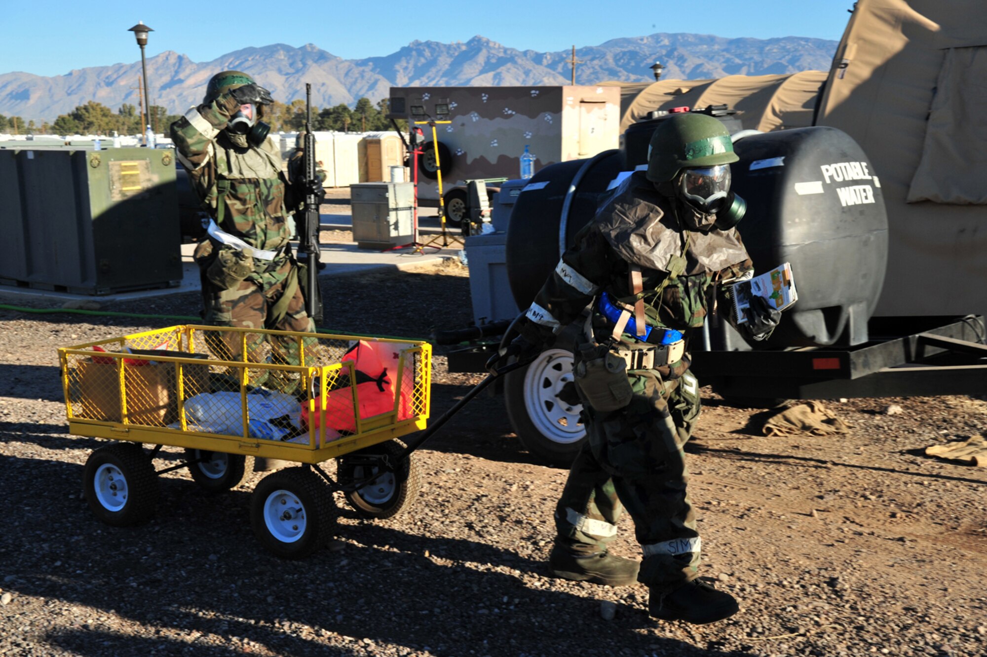 Senior Airman Jillian Knittel (right) and Staff Sgt. Christina Baca of the 355th Force Support Squadron search for unexploded ordnances during the Phase II Operational Readiness Exercise here Jan. 14. (U.S. Air Force photo/Senior Airman Noah R. Johnson)