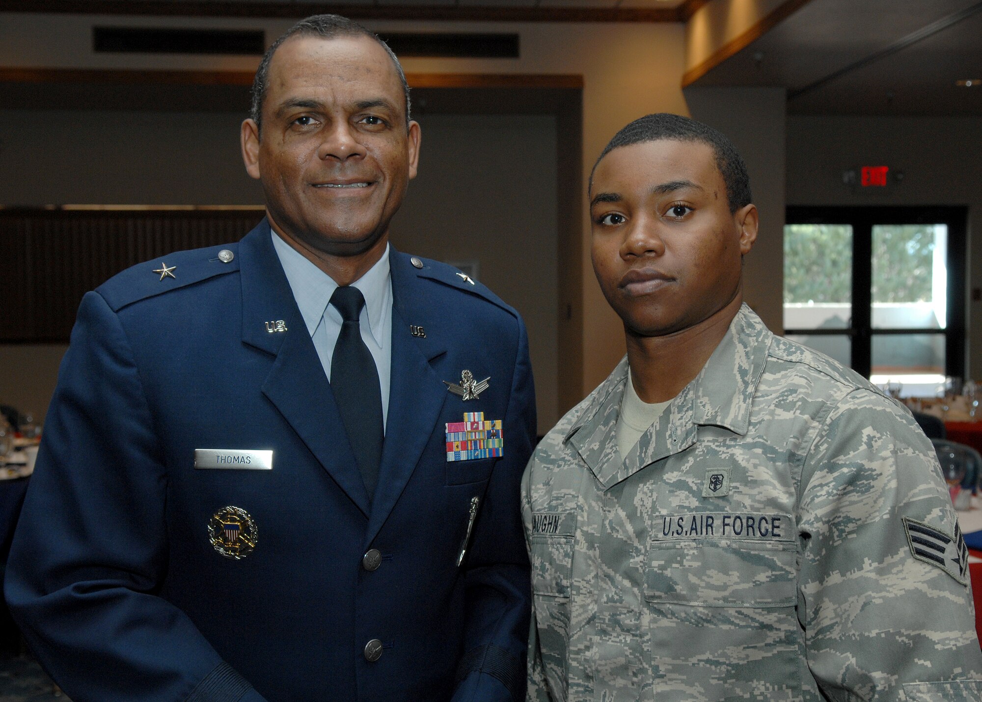 Brig. Gen. Everett H. Thomas, commander of the Air Force Nuclear Weapons Center at Kirtland Air Force Base, N.M.,  poses with Airman 1st Class Cass Vaughn, 49th Medical Group, during the Martin Luther King, Jr. observance luncheon at Holloman Air Force Base, N.M., Jan. 15. General Thomas was the guest speaker at the luncheon. He spoke about Martin Luther King, Jr., his patriotism and how his actions fit into the Air Forces core values of integrity first, service before self and excellence in all we do. (U.S. Air Force photo/Senior Airman Anthony Nelson)