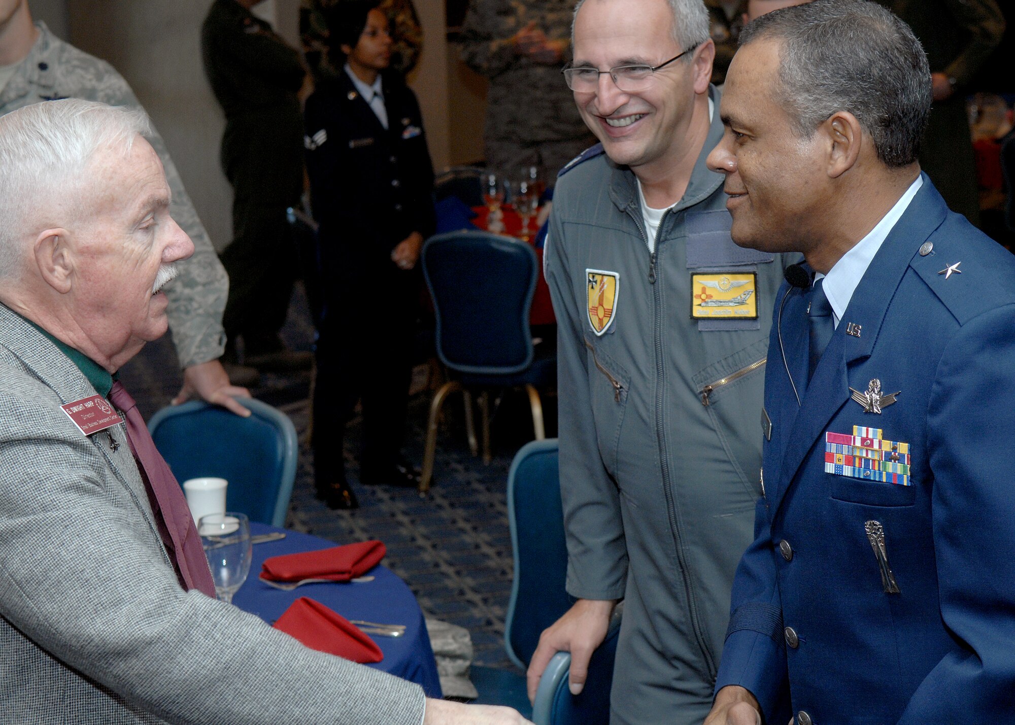 Brig. Gen. Everett H. Thomas, commander of the Air Force Nuclear Weapons Center at Kirtland Air Force Base, N.M.,  speaks to base wingman, Dwight Harp, and Lt. Col. Hans Weber, German air force Flying Training Center, during the Martin Luther King, Jr. observance luncheon at Holloman Air Force Base, N.M., Jan. 15. General Thomas was the guest speaker at the luncheon. He spoke about Martin Luther King, Jr., his patriotism and how his actions fit into the Air Forces core values of integrity first, service before self and excellence in all we do. (U.S. Air Force photo/Senior Airman Anthony Nelson)