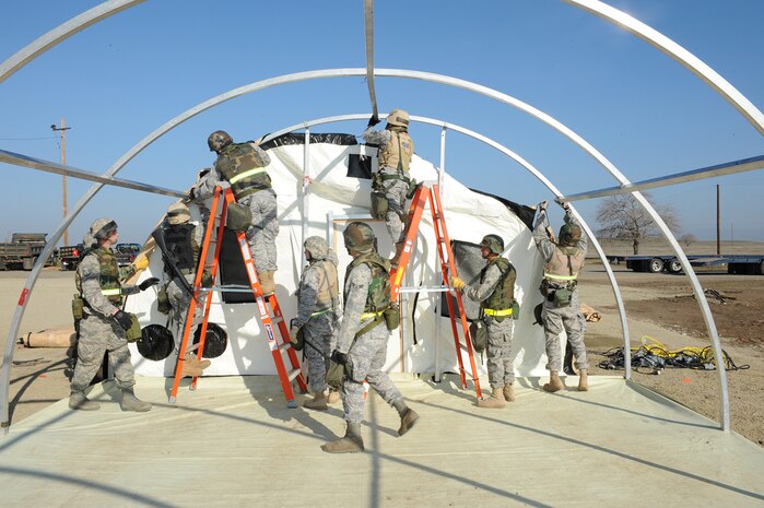 Members of the 9th Civil Engineer Squadron, near completion of their tent setup in Dragon Town during the recent Phase II Operational Readines Exercise. (Photo by Sean Bhakta)