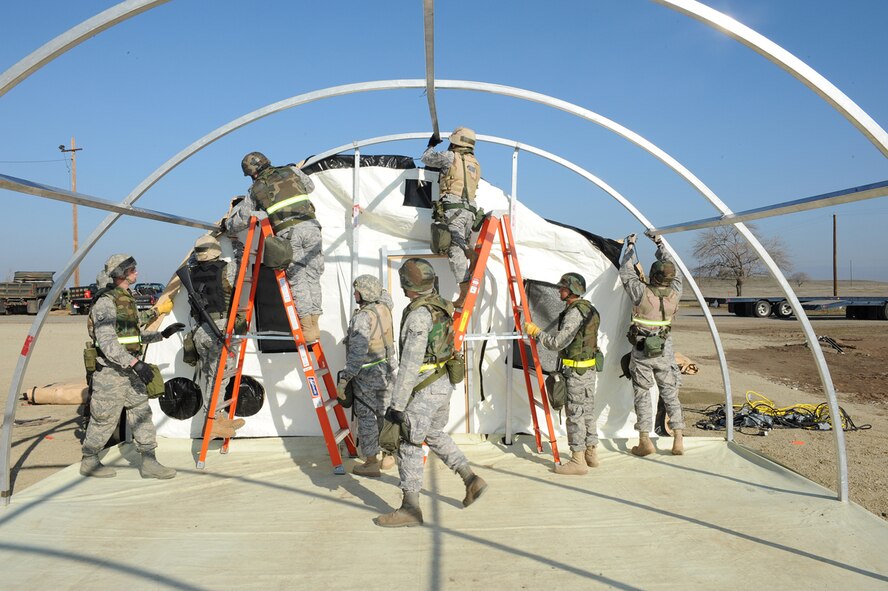 Members of the 9th Civil Engineer Squadron, near completion of their tent setup in Dragon Town during the recent Phase II Operational Readines Exercise. (Photo by Sean Bhakta)