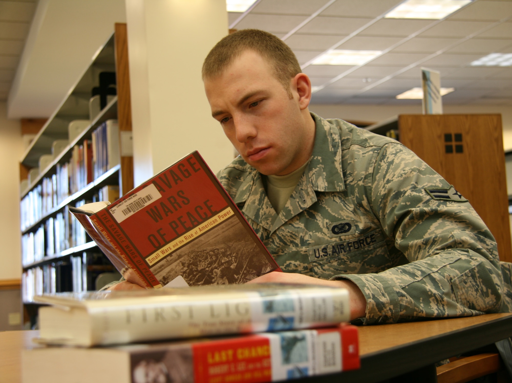 Airman First Class Zachary Vaughn, Air Combat Command, reads a book from the Chief of Staff's 2009 reading list at the Bateman Library, Langley Air Force Base, Va.  Gen. Norton Schwartz carefully selected the twelve books that make up this year's list because they contribute to an Airman's professional development, which is one of his key priorities.  ACC Airmen can check to see if their library has these books available at: http://accc.sirsi.net/uhtbin/cgisirsi/x/x/0/49 (U.S. Air Force photo by Master Sgt. Steven Goetsch)