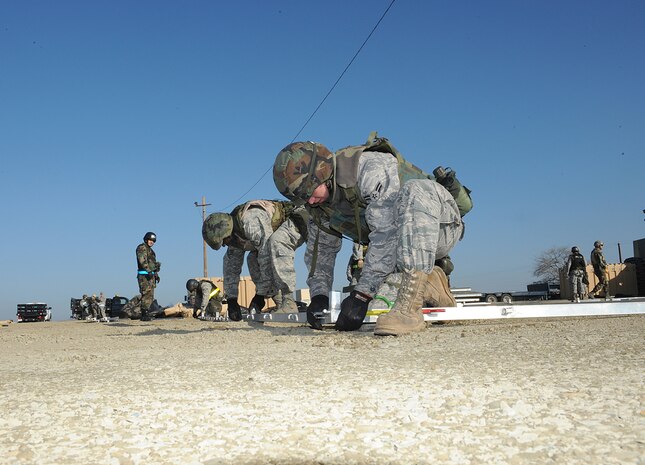 Members of the 9th Civil Engineer Squadron, begin setting up a tent in Dragon Town during the recent Phase II Operational Readines Exercise. The exercise helped prepare Beale members for the November inspection and also provided Airmen with relevant training. (Photo by Sean Bhakta)