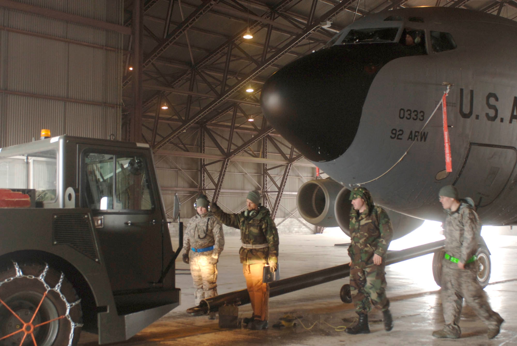 FAIRCHILD AIR FORCE BASE, Wash- Crew chiefs from the 92nd Aircraft Maintenance Squadron release the KC-135 stratotanker after towing it into a nearby hanger Jan. 15. While members of the 92nd ARW were on an exercise, maintainers left behind take the opportunity to focus on more of the minor issues of the planes. Crew chiefs are responsible for maintenance and uptake of aircraft regardless of weather. (U.S. Air Force photo / Airman 1st Class Darlene West)