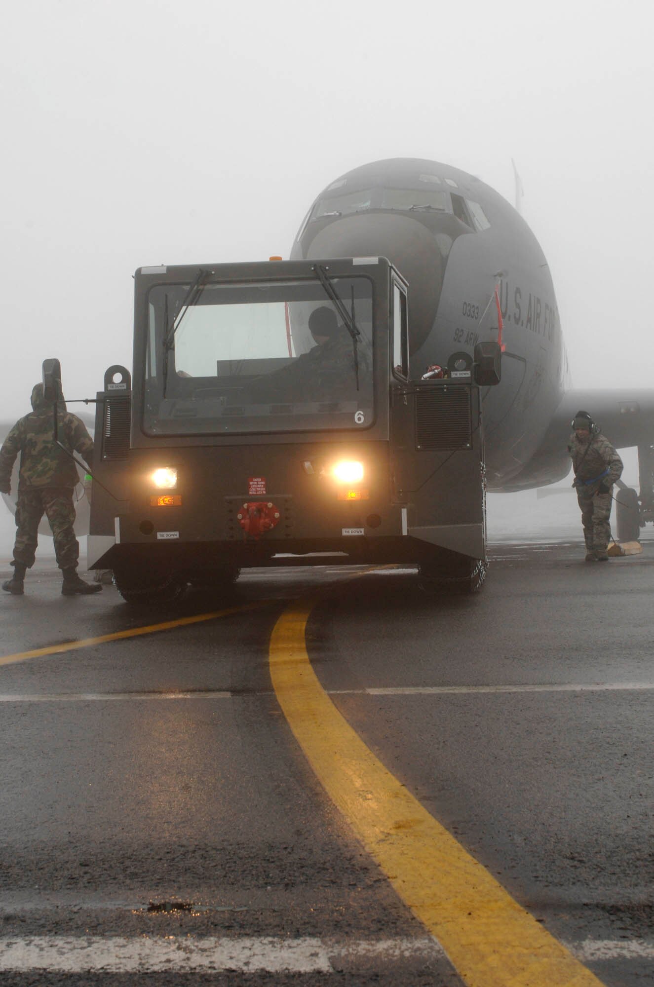 FAIRCHILD AIR FORCE BASE, Wash- 92nd Aircraft Maintenance Squadron crew chiefs perform necessary procedures before hooking the uke to the KC-135 stratotanker on the flightline Jan. 15. The KC-135 stratotanker was towed into a nearby hangar for routine maintenance. The reduction of flying sorties has provided a good opportunityfor maintainers to work on the minor issues with the aircraft. (U.S. Air Force photo / Airman 1st Class Darlene West)