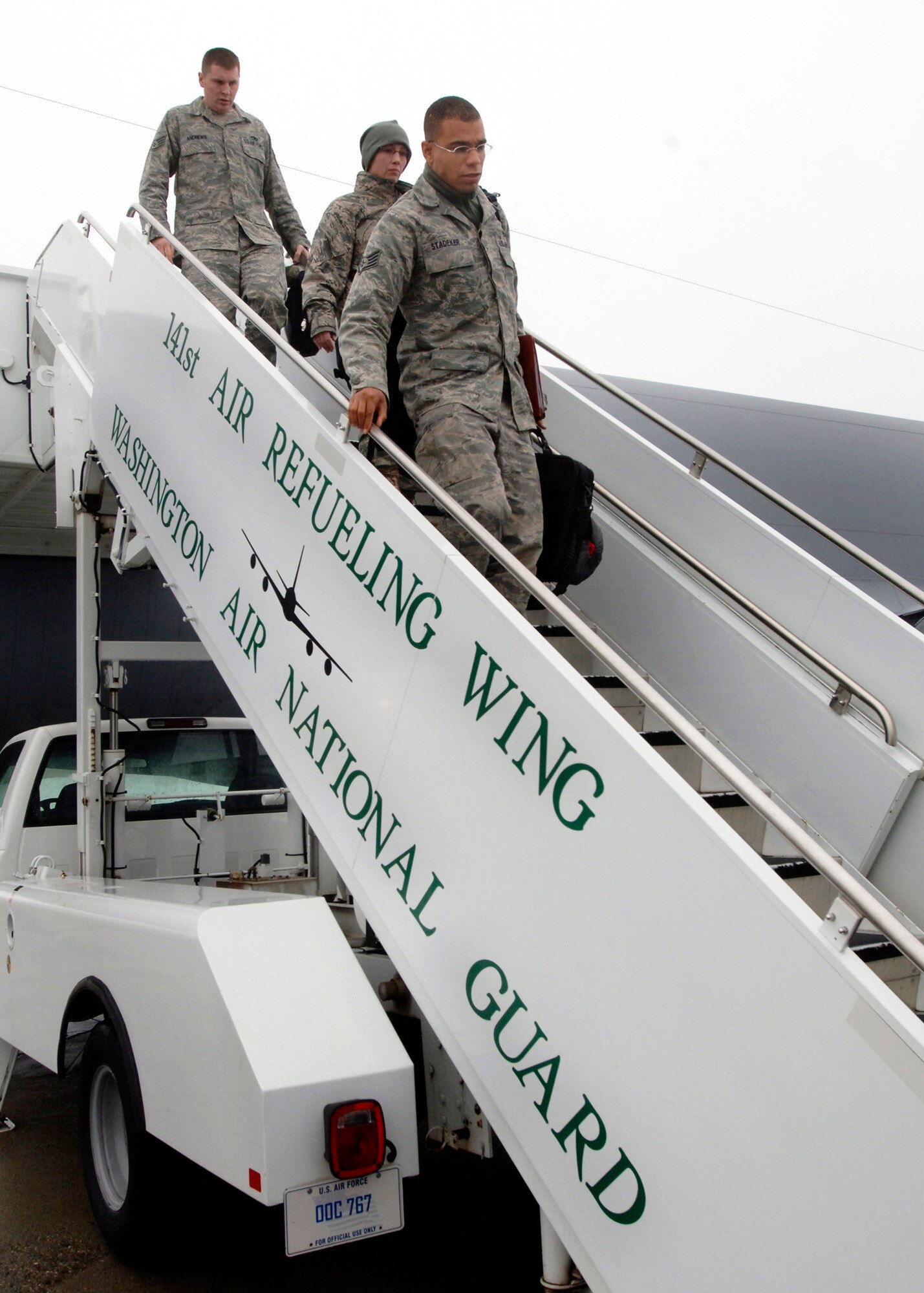 FARICHILD AIR FORCE BASE, Wash. –Staff Sgt. Devin Stadeker, 92nd Maintenance Squadron, Arrow Repair Journeyman, and Staff Sgt. Ryan Andrews, 92nd Air Maintenance Squadron,  KC-135 Hydraulics Craftsman, step off a KC-135 after a very long awaited arrival home to Fairchild after a 4 month tour to a deployed environment, Jan 12. (U.S. Air Force photo / Airman 1st Class Melissa L. Barnett)