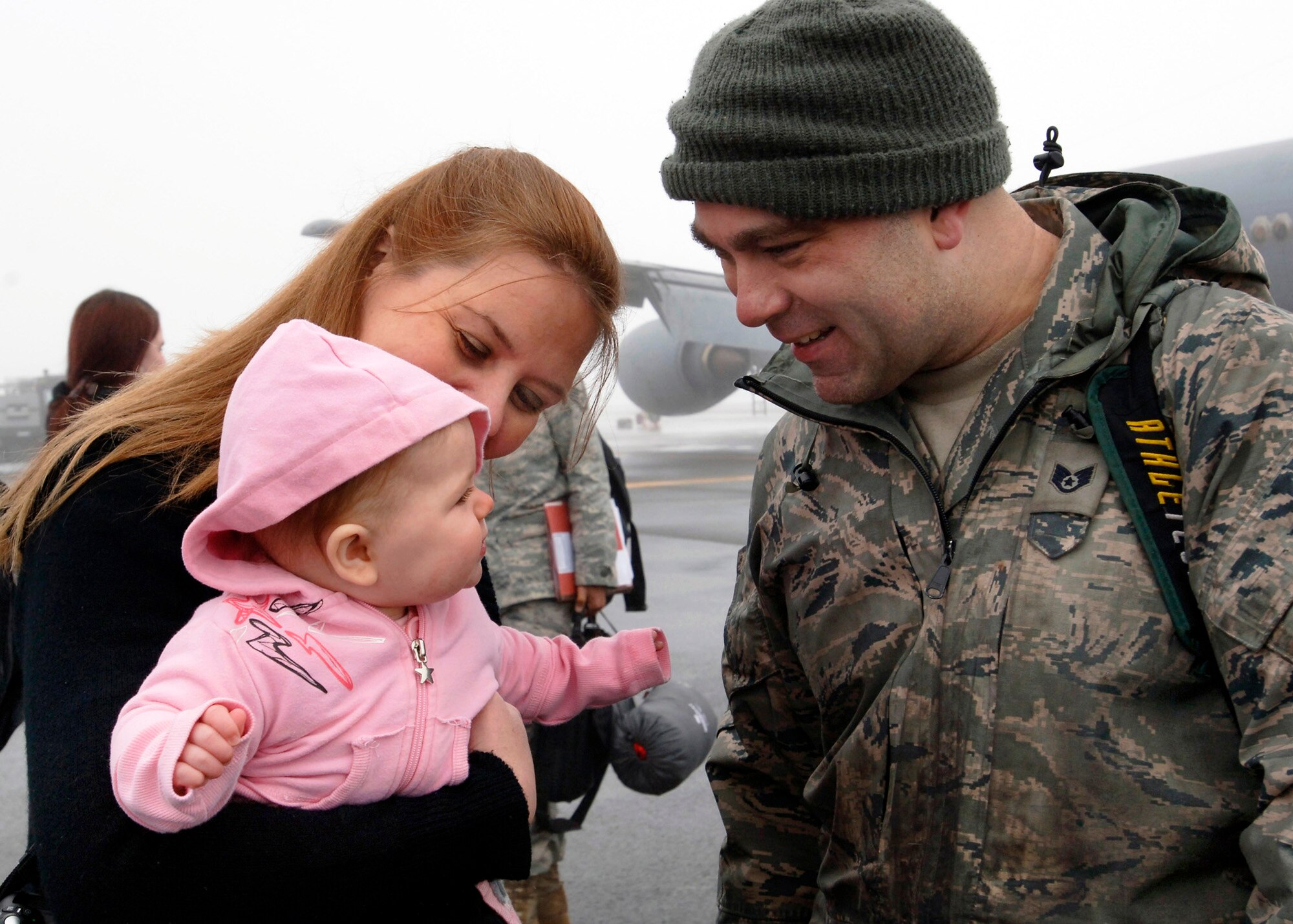 FAIRCHILD AIR FORCE BASE, Wash. –Staff Sgt. Casey Richards, 92 Maintenance Squadron, Electrical Environmentalist, is reunited with his wife Kayla and daughter Krystal after spending 4 months in a deployed environment,  Jan. 12. (U.S. Air Force photo / Airman 1st Class Melissa L. Barnett)