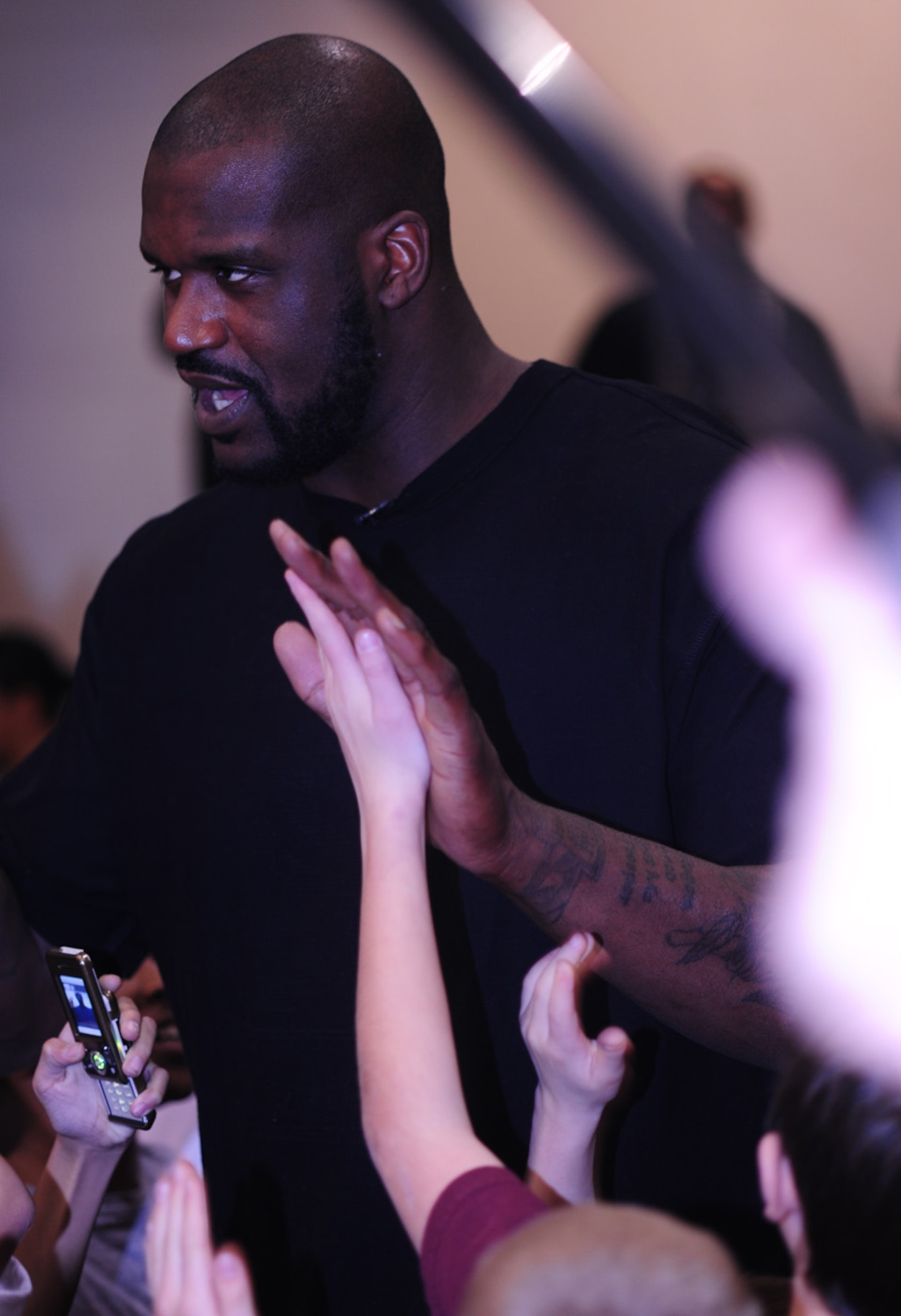 BUCKLEY AIR FORC BASE, Colo -- Shaquille O'Neal, Phoenix Suns center, shook hands with or high fived some of the more than 265 children of military members during a basketball clinic here Jan. 14. Mr. O'Neal spoke to the children about what it was like for him growing up in a military environment. The visit was filmed and portions will air during a youth concert in Washington D.C. attended by the first and second ladies on the Disney Channel and Disney Radio Jan. 19 from 6:00 - 7:30 p.m. MST. (U.S. Air Force photo by Senior Airman Alex Gochnour)