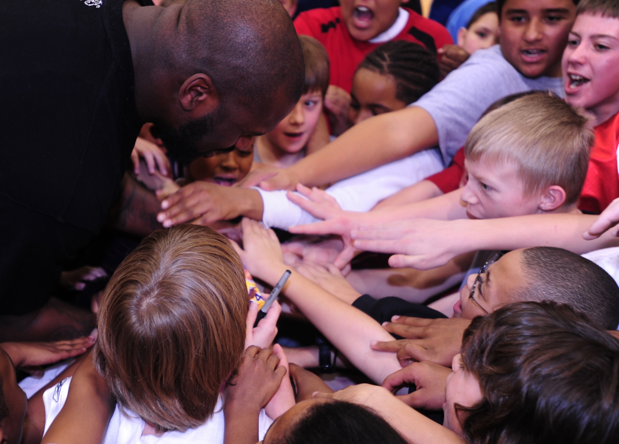 BUCKLEY AIR FORC BASE, Colo -- Shaquille O'Neal, Phoenix Suns center, gets the kids pumped up with a "One, two, three, Buckley" chant during a basketball clinic here Jan. 14. Mr. O'Neal spoke to more than 265 children of military members about what it was like for him growing up in a military environment. The visit was filmed and portions will air during a youth concert in Washington D.C. attended by the first and second ladies on the Disney Channel and Disney Radio Jan. 19 from 6:00 - 7:30 p.m. MST. (U.S. Air Force photo by Senior Airman Alex Gochnour)