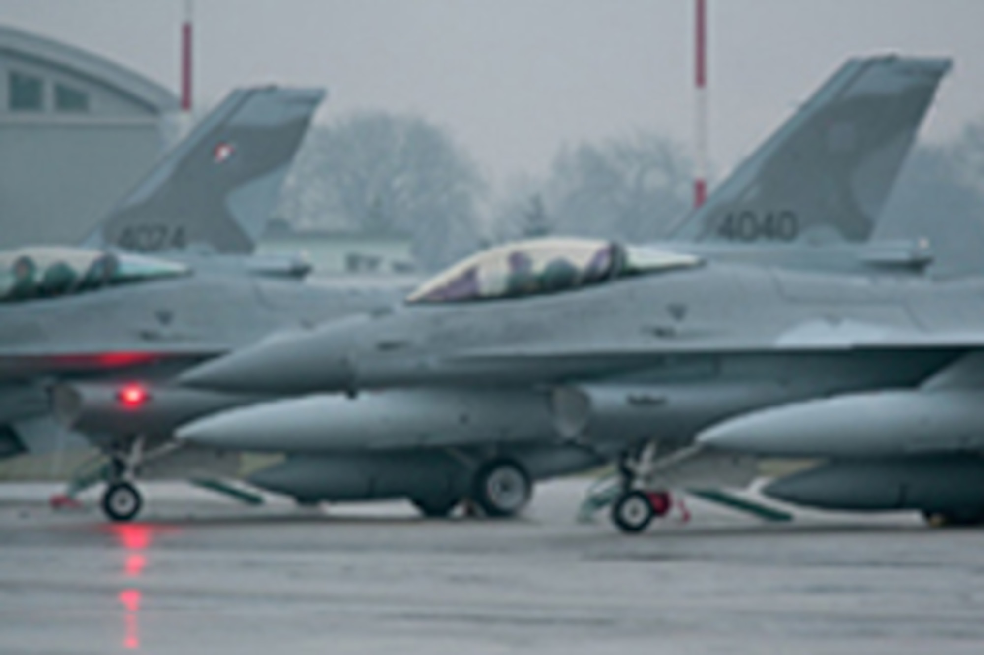 Pilots from the Arizona Air National Guard's 162nd Fighter Wing deliver the last three F-16 "Jastrzab," or Hawks as their called, to the Polish Air Force at Krzesiny Air Base, Poland, Dec. 11, 2008. These jets represent the last of 48 aircraft Poland purchased as part of the "Peace Sky" program. Poland continues to send F-16 student pilots to the 162nd at Tucson International Airport for training. (U.S. State Department photo)