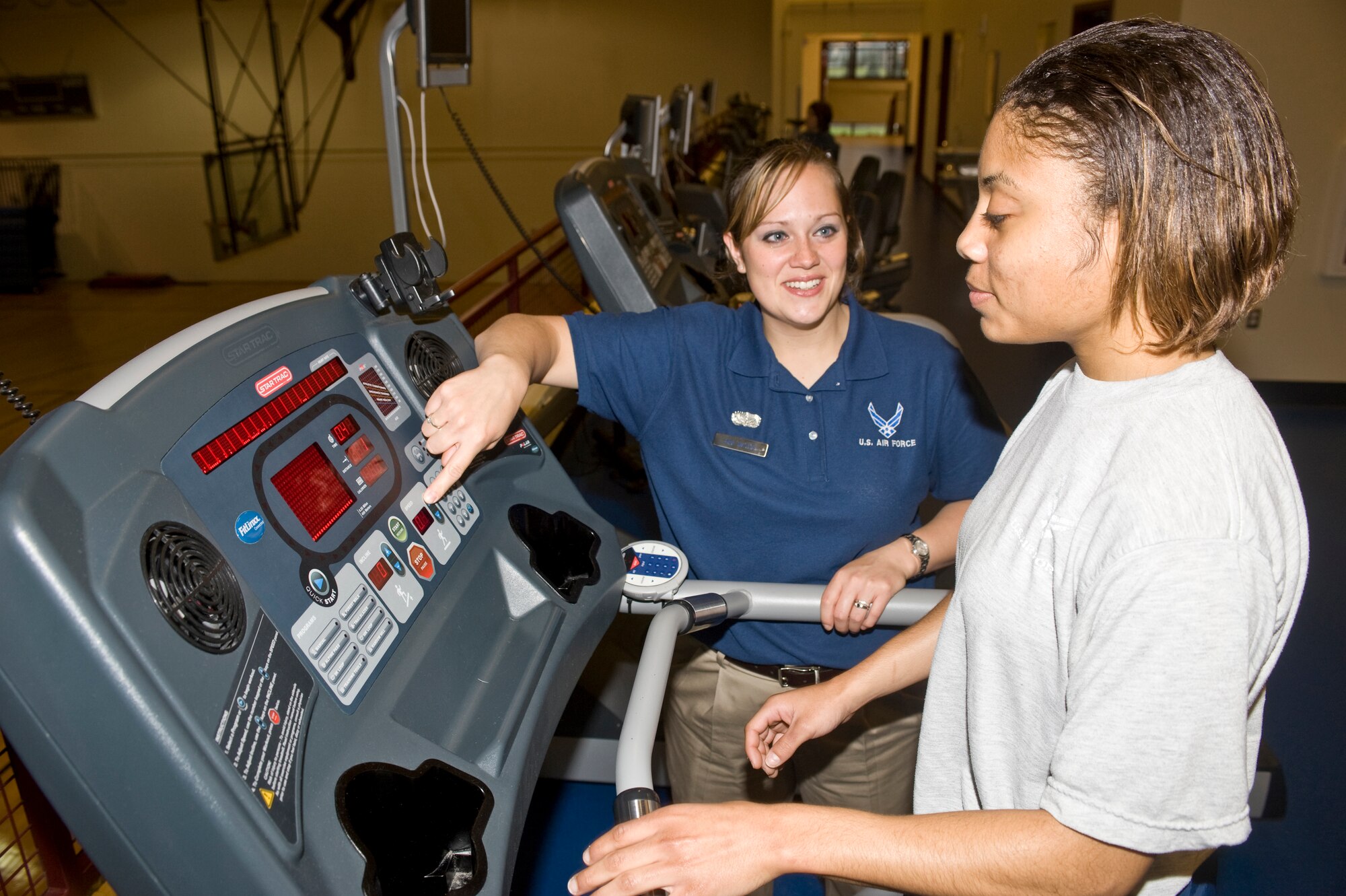 ELMENDORF AIR FORCE BASE, Alaska--Senior Airman Theresa Mathis instructs Senior Airman Cortney Bowman on how to operate a treadmill correctly at the Elmendorf Fitness Center, Aug. 28, 2008. The Elmendorf Fitness Center has met the criteria to receive its first 5 star rating as a fitness facility within the U.S. Air Force this year. (U.S. Air Force photo/ Senior Airman Matthew Owens)