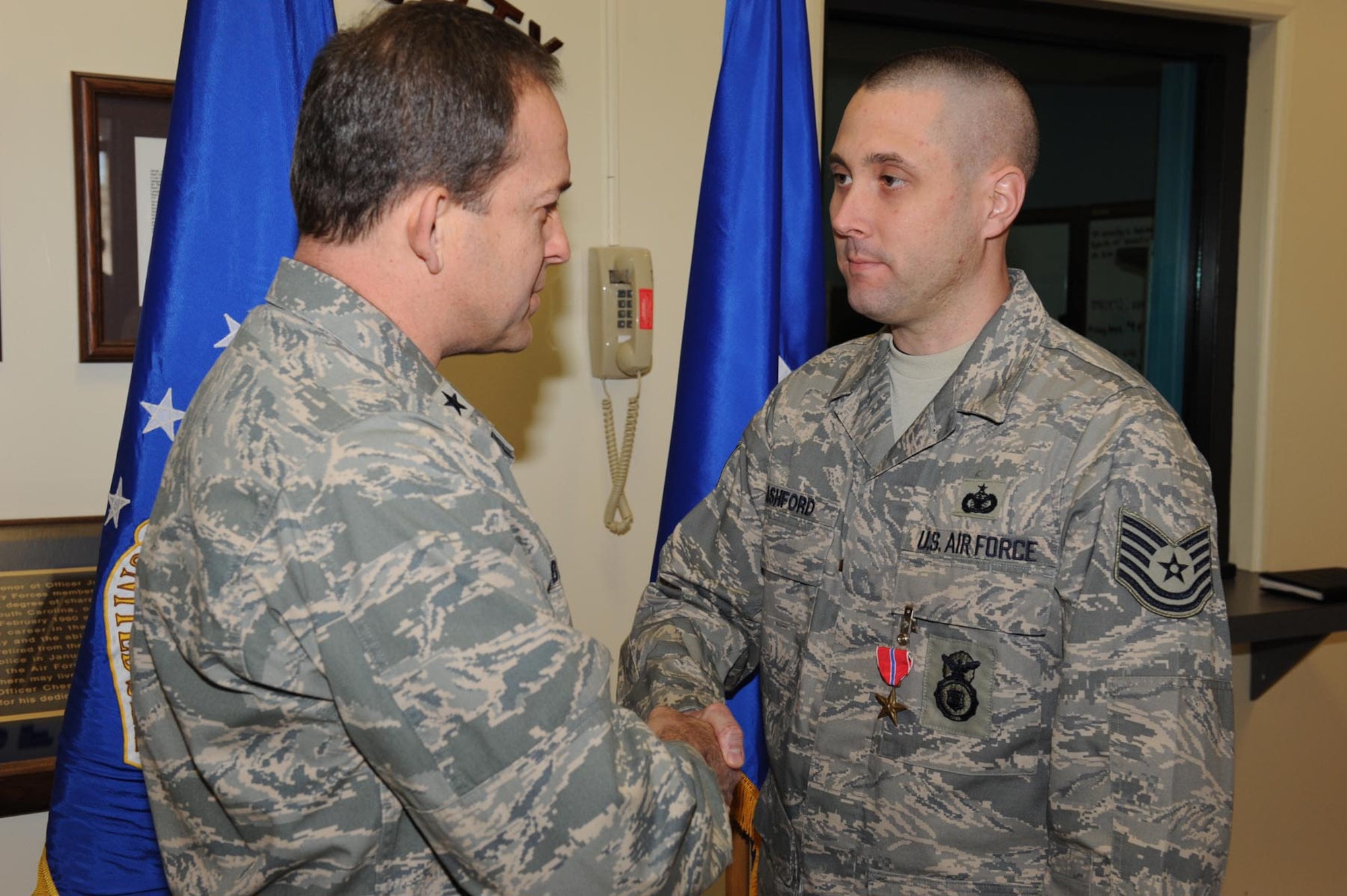 SHAW AIR FORCE BASE, S.C. -- Tech. Sgt. Patrick Ashford, 20th Security  Forces Squadron, receives the Bronze Star Medal from Brig. Gen. Timothy Byers, Air Combat Command director mission support and installations, for his meritorious actions while deployed in Iraq December 16, 2009.(U.S. Air Force photo/Senior Airman Matthew Davis) 