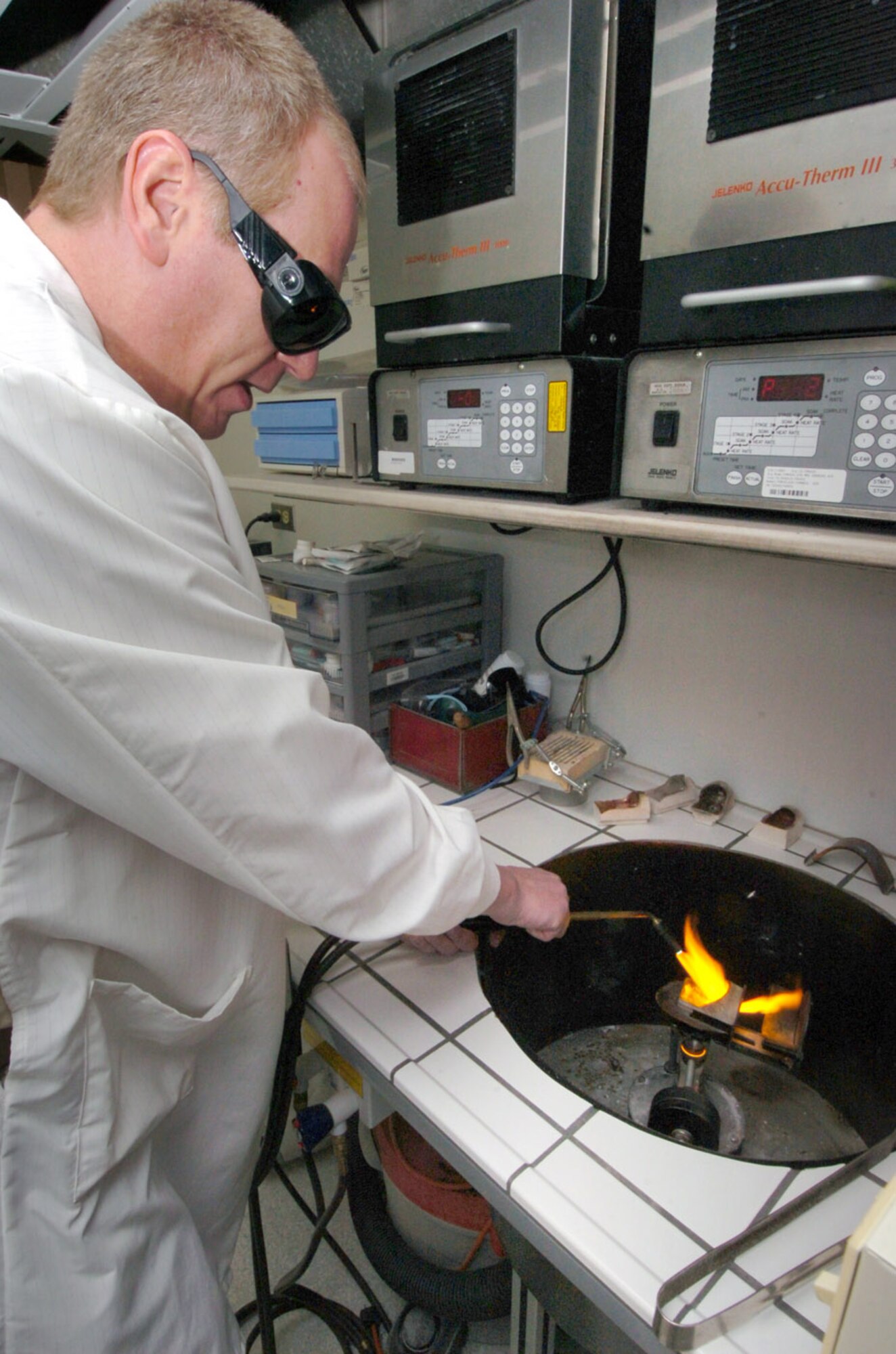 Techichal Sgt. David Napoletano, 779th Dental Squadron dental laboratory assistant NCO in charge, melts down gold at 2,650 to 2,760 degrees inside a casting well. The gold will be used for a patients crown. (U.S. Air Force photo by Bobby Jones)
