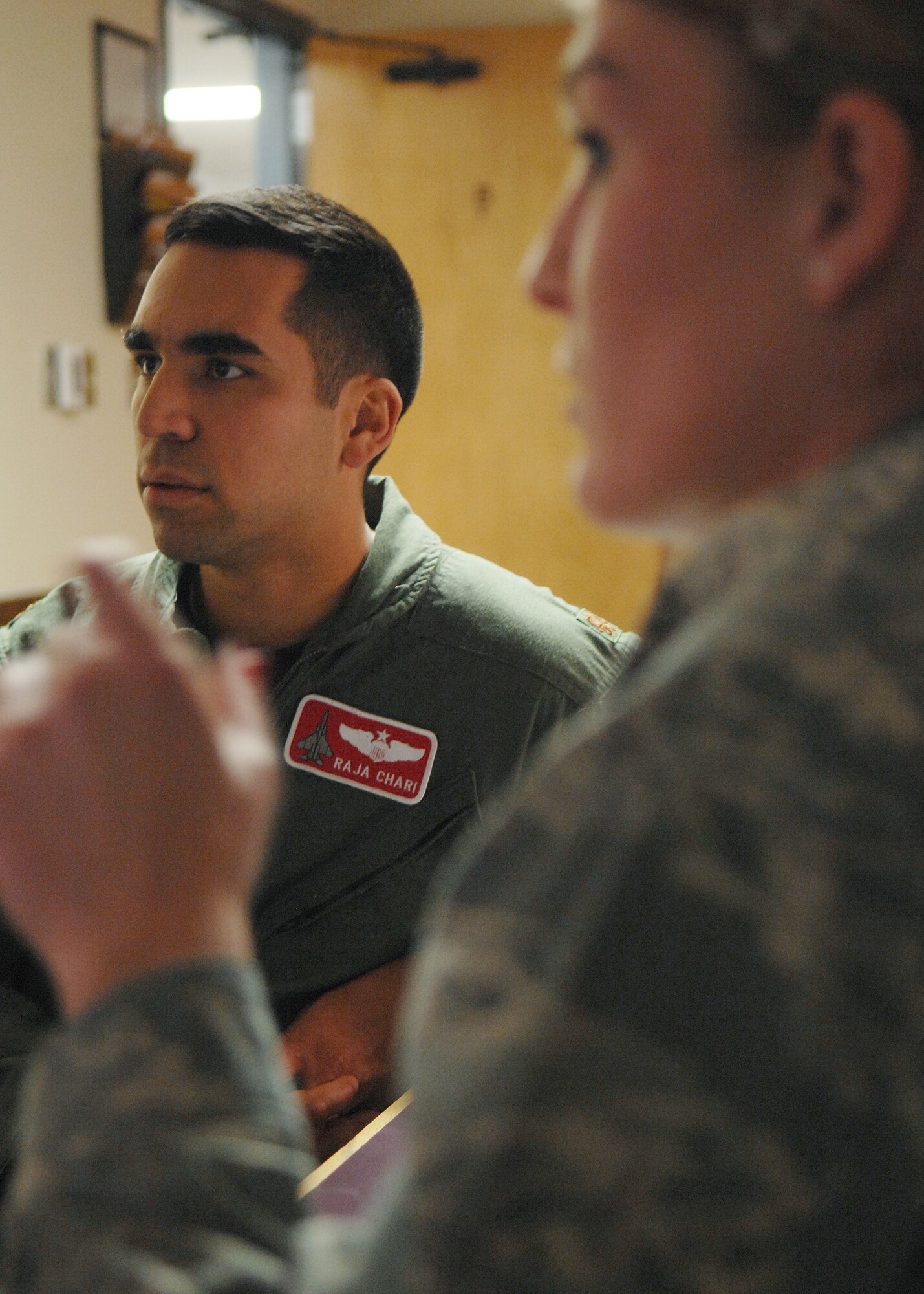 2nd Lt. Shawnalee Bradley, debriefs Maj. Raja Chari after completing the centrifuge, Jan. 14, at Holloman Air Force Base, N.M. Major Chari is assigned to the 40th Flight Test Squadron, 46th Test Wing, Air Force Material Command. He was the 30,000 student to go through the course. (U.S. Air Force photo/ Senior Airman Anthony Nelson)
