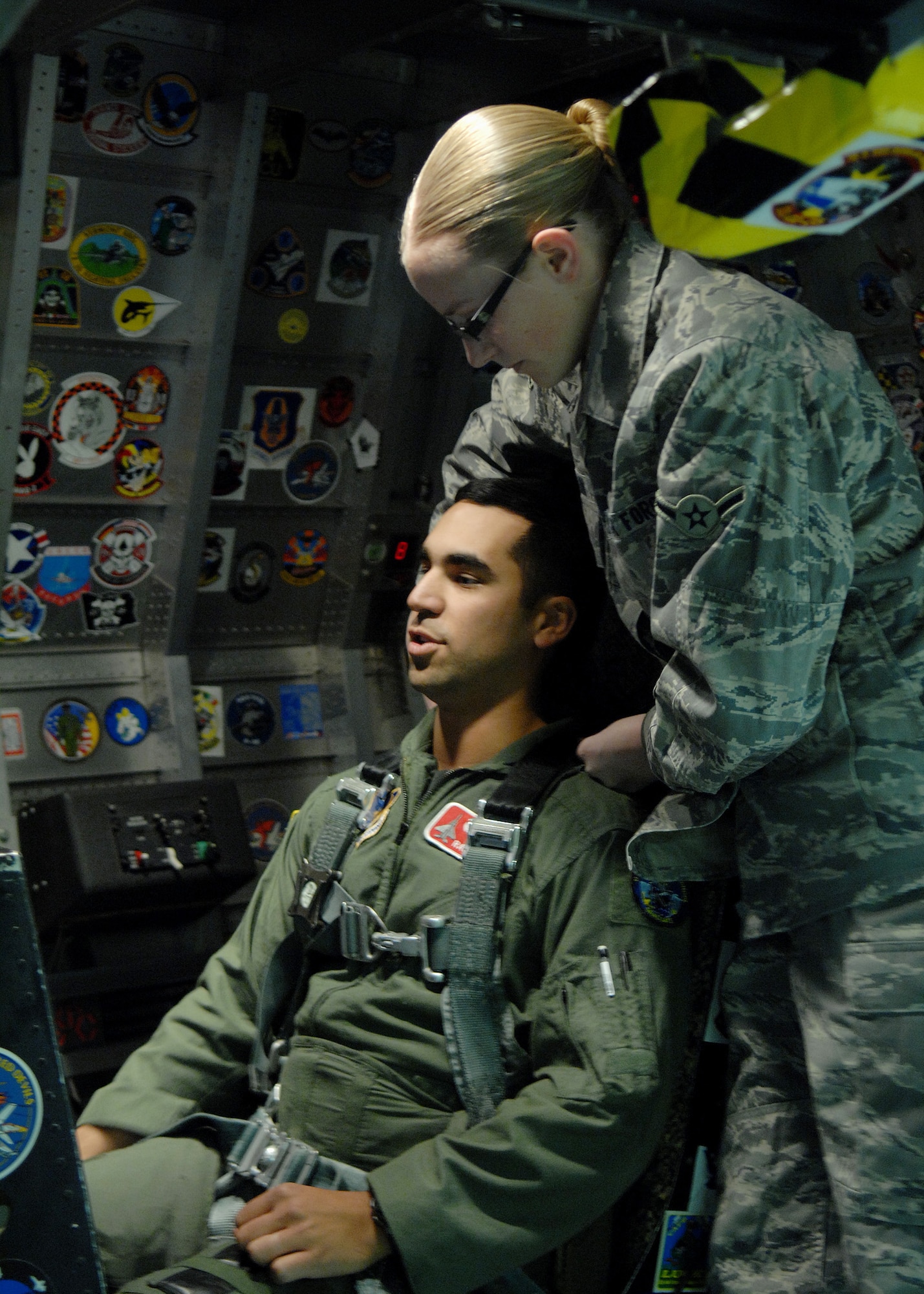 Airman Breanne Blain checks Maj. Raja Chari's G-Suit and straps him into the cockpit before beginning the human centrifuge, Jan. 14, at Holloman Air Force Base, N.M. Major Chari is assigned to the 40th Flight Test Squadron, 46th Test Wing, Air Force Material Command. He was the 30,000 student to go through the course. (U.S. Air Force photo/ Senior Airman Anthony Nelson)
