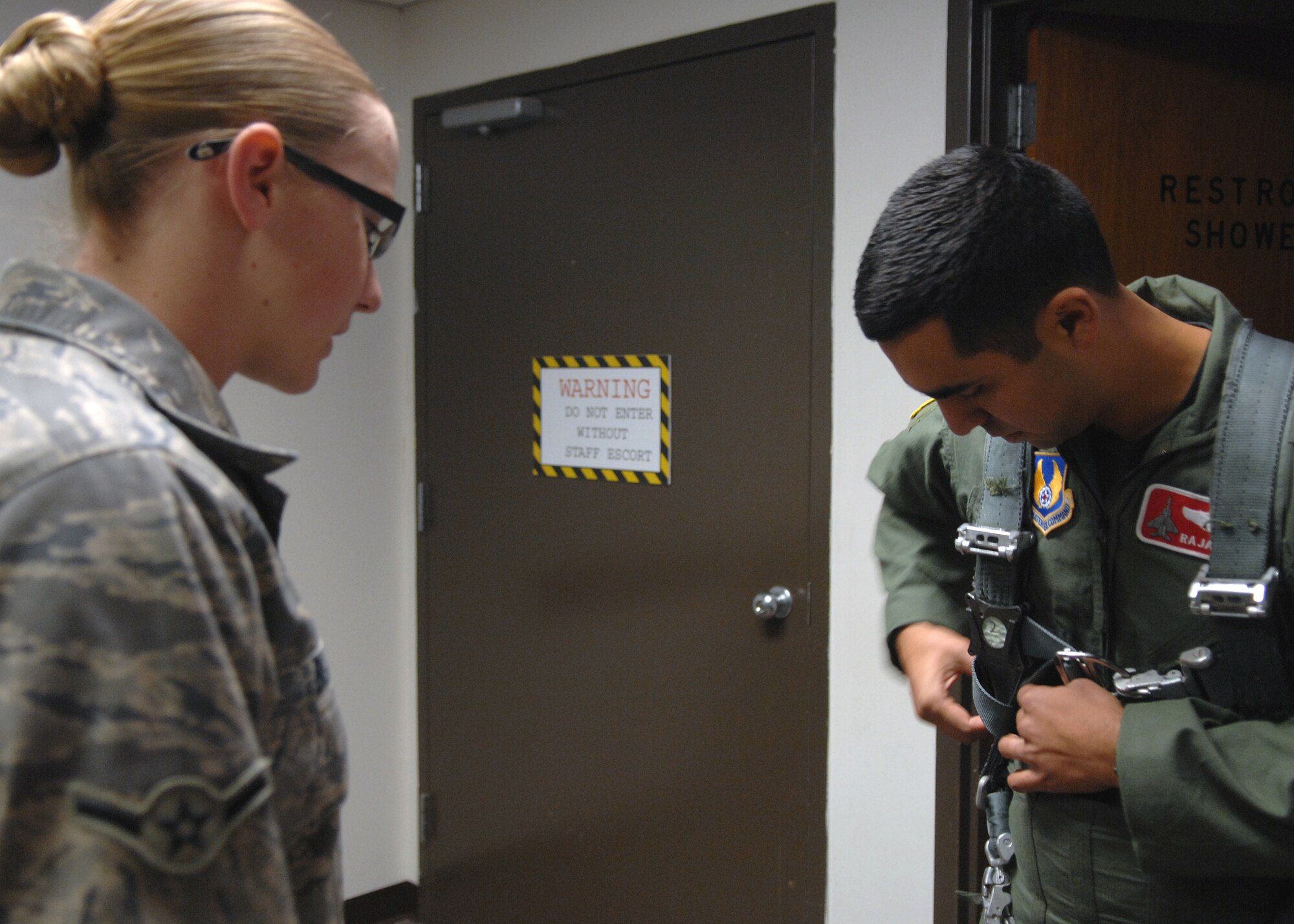 Airman Breanne Blain checks Maj. Raja Chari's G-Suit, before entering into the human centrifuge, Jan. 14, at Holloman Air Force Base, N.M. Major Chari is assigned to the 40th Flight Test Squadron, 46th Test Wing, Air Force Material Command. He was the 30,000 student to go through the course. (U.S. Air Force photo/ Senior Airman Anthony Nelson)
