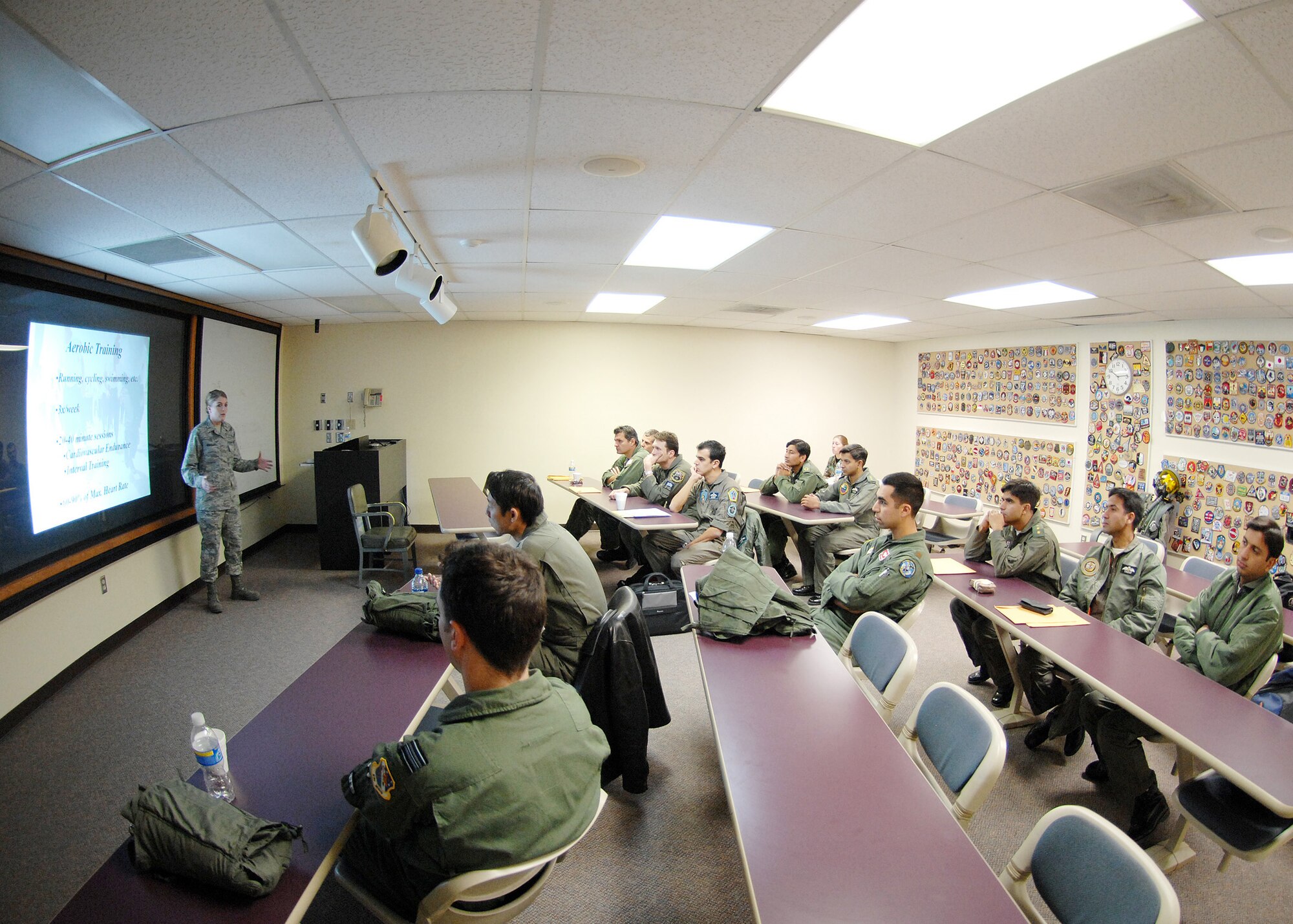 2nd Lt. Shawnalee Bradley, centrifuge training instructor, explains to her class the importance of aerobic training and physical fitness before getting into the human centrifuge, Jan. 14, at Holloman Air Force Base, N.M. Lieutenant Bradley is an aerospace physiologist assigned to 49th Fighter Wing. The centrifuge at Holloman AFB is operated by the aerospace physiology department for the purpose of training and evaluating prospective fighter pilots for high-g flight in Air Force fighter aircraft. (U.S. Air Force photo/ Senior Airman Anthony Nelson Jr)
