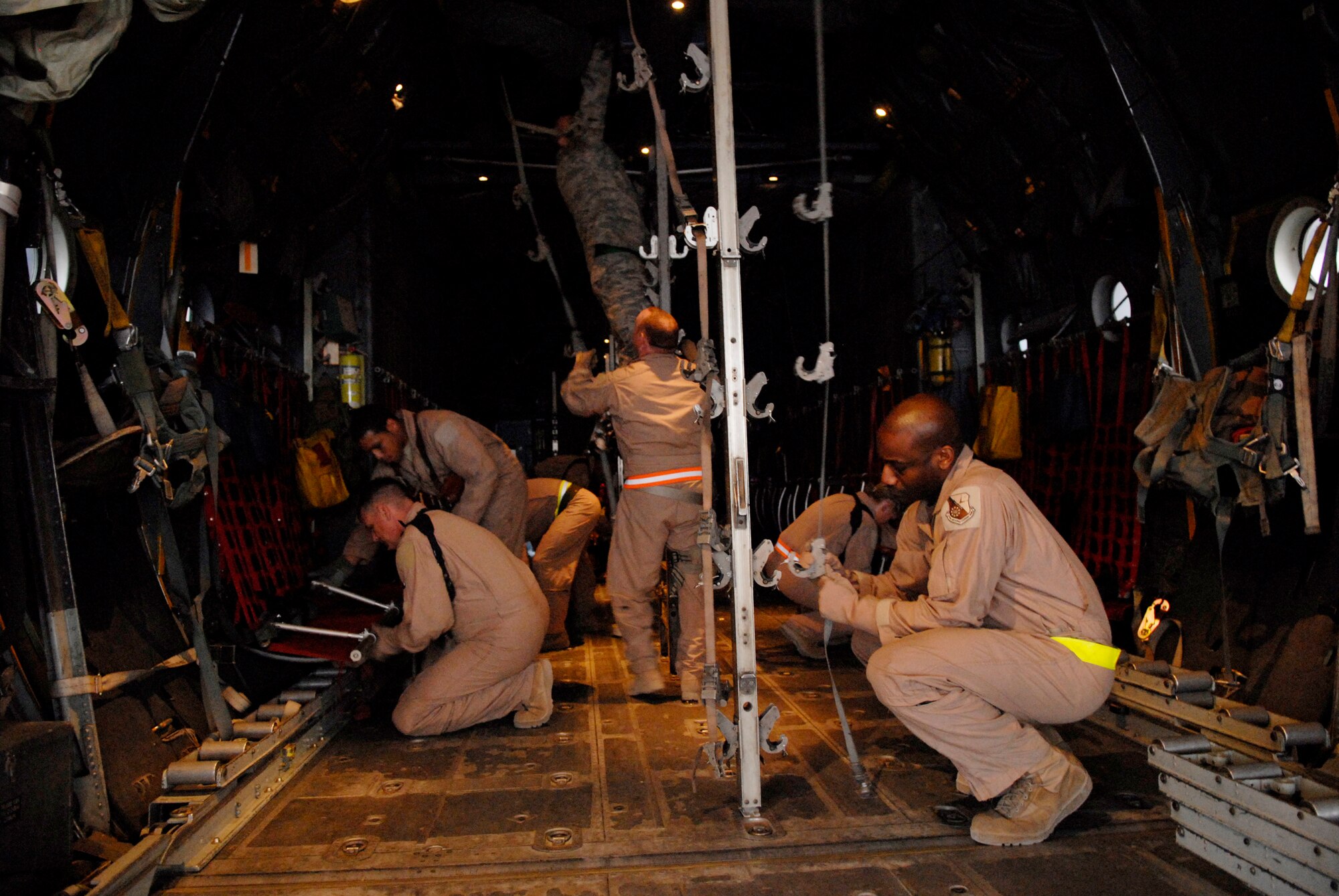 Airmen configure an aircraft to handle patients and medical equipment before a mission Jan. 11 at an air base in Southwest Asia. The 379th Expeditionary Aeromedical Evacuation Squadron members transport wounded warriors from operations Iraqi Freedom and Enduring Freedom. (U.S. Air Force photo/Airman 1st Class Andrew Satran)
