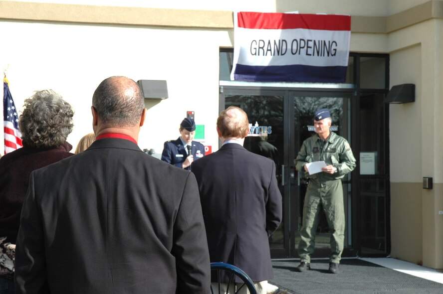 Col. Steve Chapman, 919th Special Operations Wing commander, listens as Capt. Kirstin Glaser, 919th Logistics Readiness Squadron, makes welcoming remarks during Thursday's grand re-opening ceremony for Duke Field's fully renovated visiting quarters.  He later cut the ribbon on the three-story lodging facility after an 18-month, $5.6 million renovation project he said brought state-of-the-art amenities to a facility that for years failed to meet Air Force lodging standards.  The renovation, funded by Air Force Reserve Command, features 48 private rooms with full baths, queen-size beds, two handicapped-accessible rooms, a guest elevator and a lobby business center with computer access, a beverage bar and numerous other amenities. 