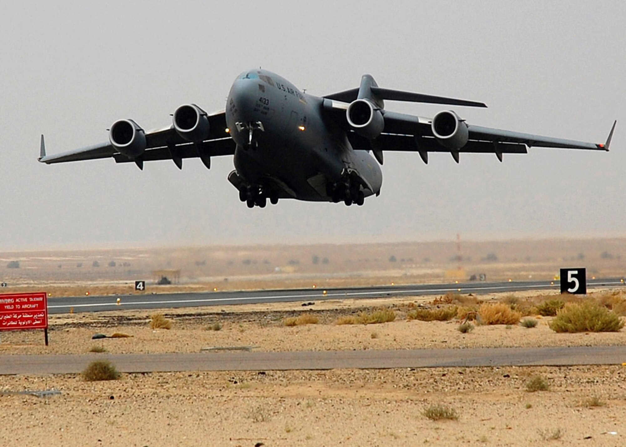 A C-17 Globemaster III takes off from an air base in Southwest Asia. The C-17's primary mission is to transport servicemembers and cargo in support of Operations Enduring Freedom and Iraqi Freedom. (U.S Air Force photo/Staff Sgt. Tia Schroeder)