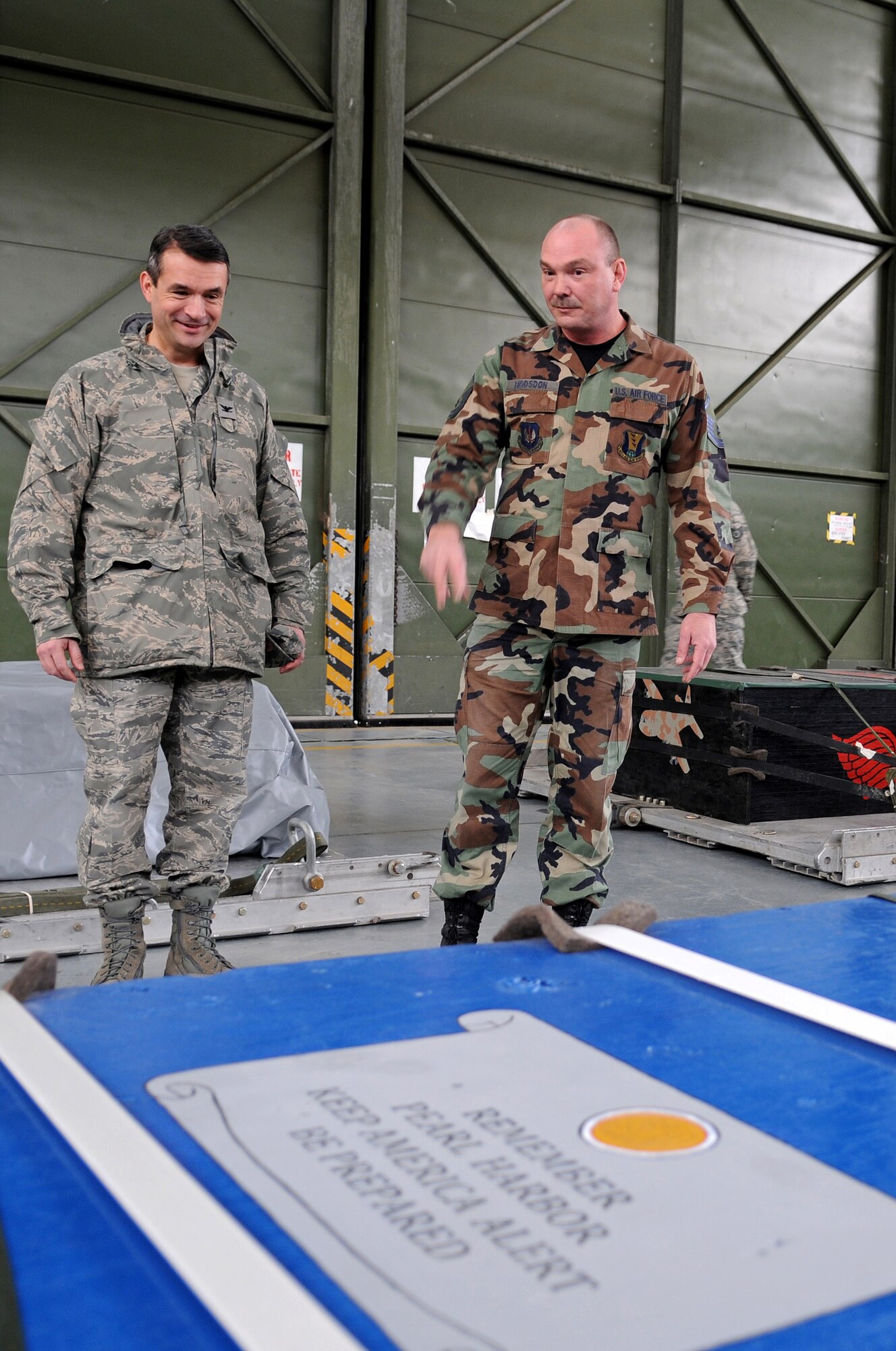 Master Sgt. David Hudson (right), 435th Logistics Readiness Squadron Aerial Delivery Riggers, showcases a heavy-cargo box to U.S. Air Force Col. Donald Bacon, 435 ABW commander at Ramstein Air Base Jan. 16, 2009. Airmen in the 435th LRS painted each of the heavy-cargo boxes with different tributes to military and U.S. events such as September 11 and Pearl Harbor. Their latest tribute was to Colonel Bacon and the 435th ABW. (U.S. Air Force photo by Airman 1st Class Grovert Fuentes-Contreras)
