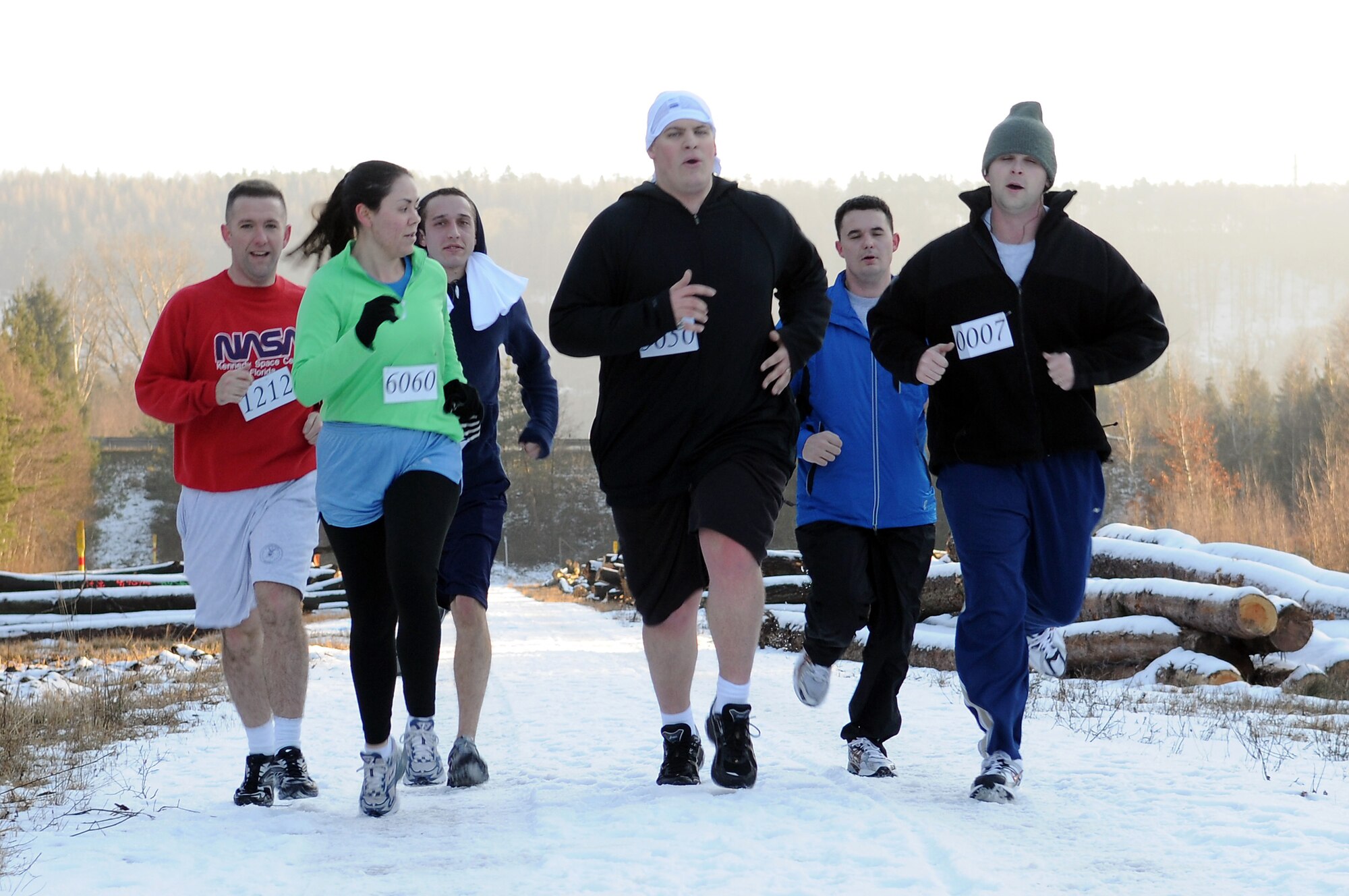 Participants run toward the finish line to complete the Penguin Prediction Run hosted by the 450th Intelligence Squadron at the Construction Training Squadron (CTS) course on Ramstein Air Base Jan. 15, 2009.  The run was held aiming to promote fitness and increase awareness of the challenges facing women and children in Pristina, Kosovo. (U.S. Air Force photo by Airman 1st Class Caleb Pierce)  
