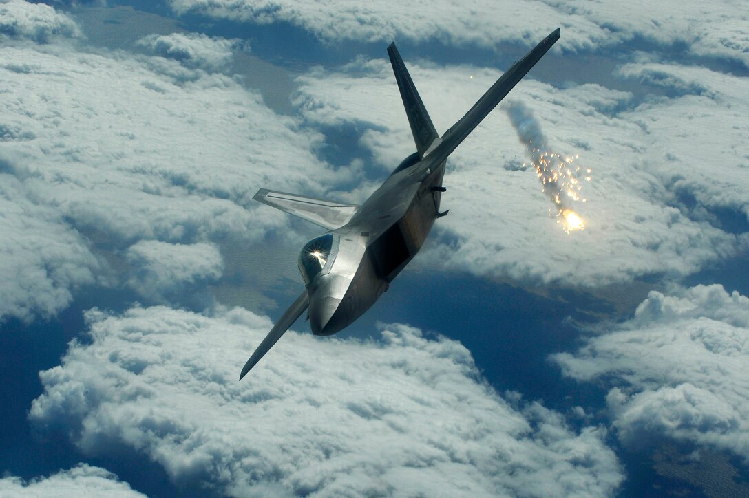 An F-22 Raptor shoots out a flare during an air combat training mission Jan. 15. The F-22 is deployed to Kadena Air Base, Japan, from the 27th Fighter Squadron at Langley Air Force Base, Va., in support of U.S. Pacific Command. (U.S. Air Force photo/Senior Airman Clay Lancaster) 
