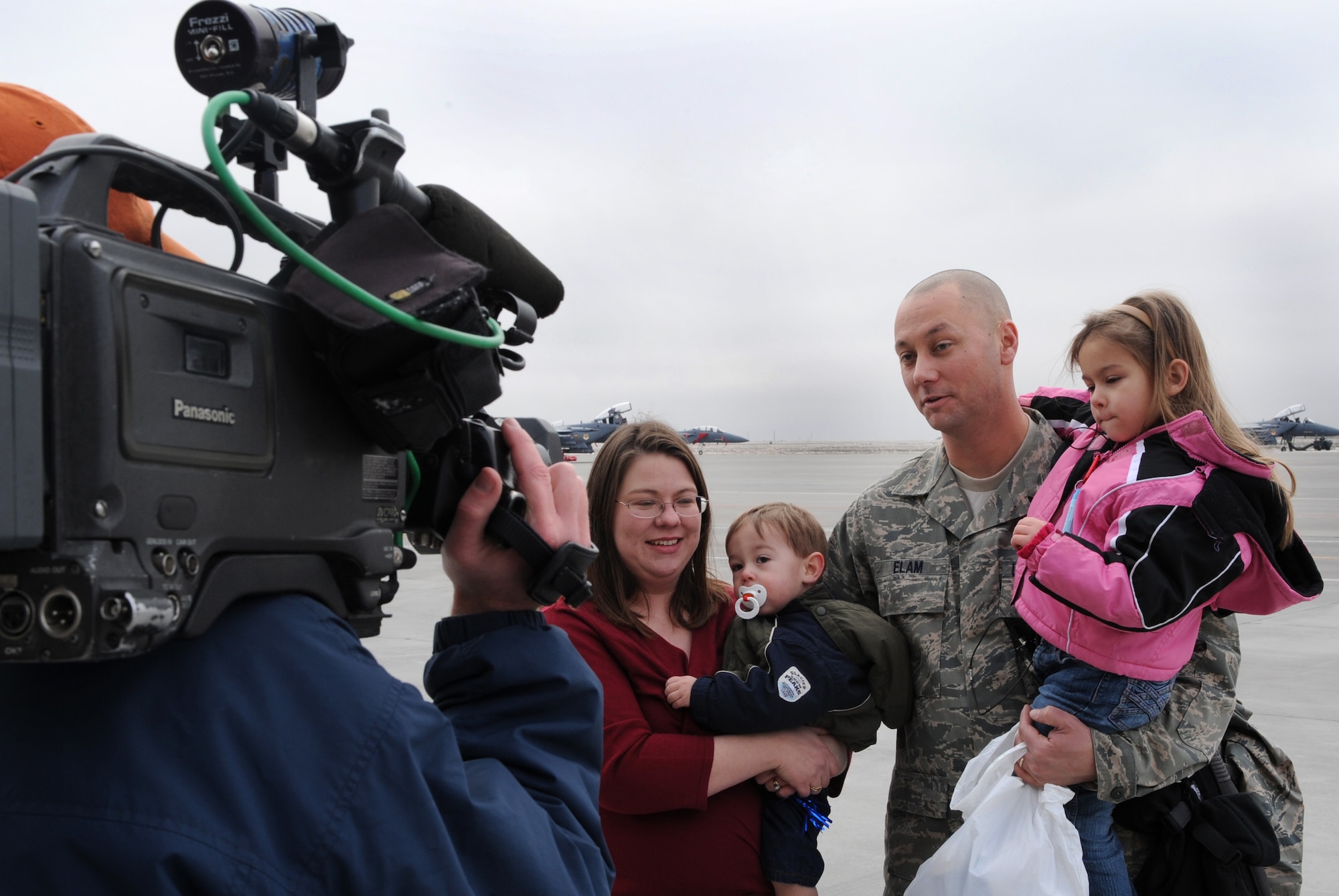 MOUNTAIN HOME AIR FORCE BASE, ID -- Tech. Sgt. Justin Elam, 391st Fighter Squadron, gives an interview with his family after returning from his deployment Jan. 15. Approximately 400 Gunfighters returned to Idaho following more than four months of combat operations in Afghanistan in support of Operation Enduring Freedom. (U.S. Air Force photo by Airman First Class Debbie Lockhart)