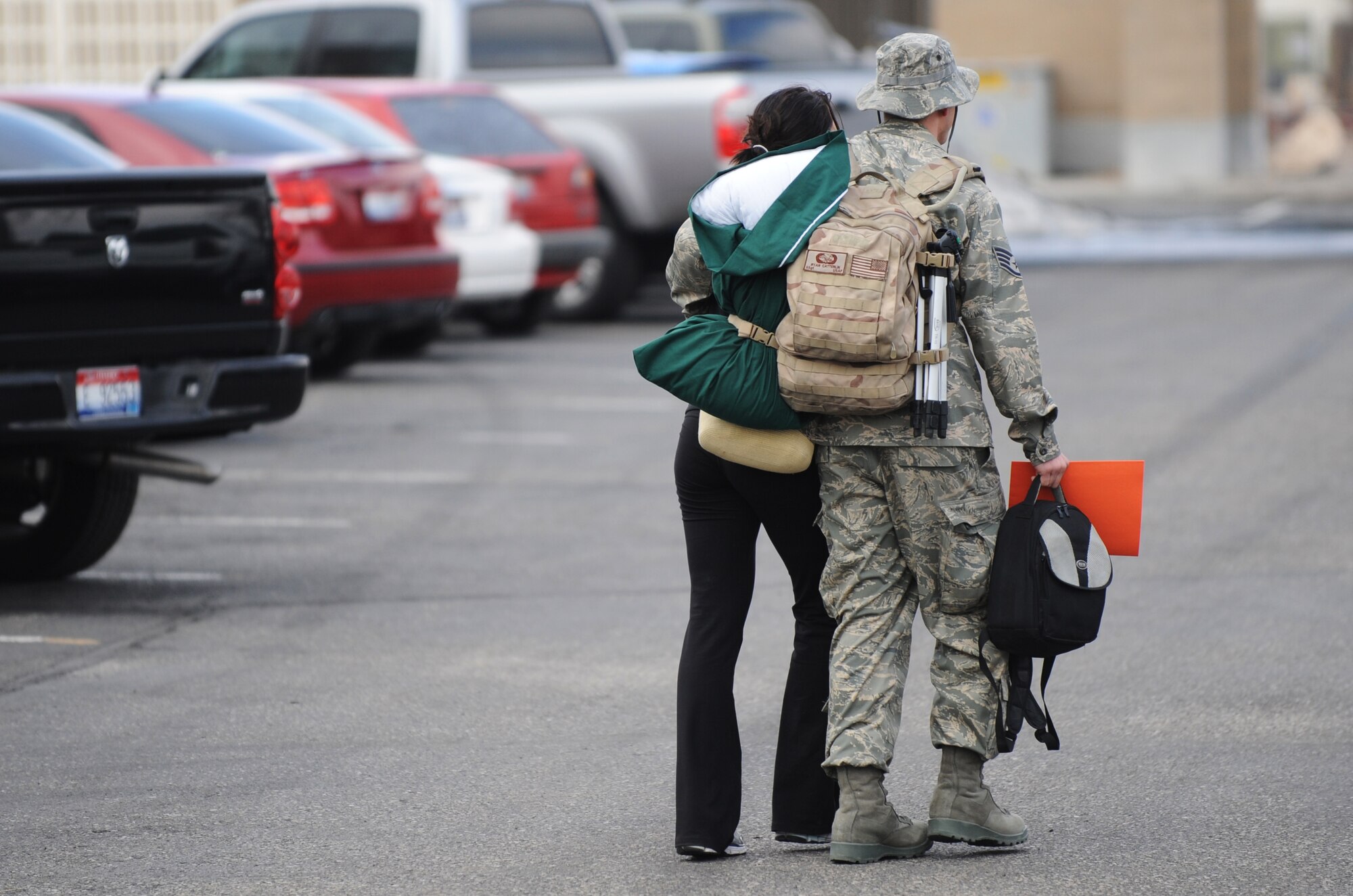 MOUNTAIN HOME AIR FORCE BASE, Idaho -- Staff Sgt. Ryan Catterlin, 366th Aircraft Maintenance Unit, walks to his car with his wife after returning from a four-month deployment to Afghanistan Jan. 15. Nearly 20 F-15E Strike Eagles and approximately 400 Gunfighters were deployed to Afghanistan in support of Operation Enduring Freedom. (U.S. Air Force photo/ Senior Airman Ryan Crane)