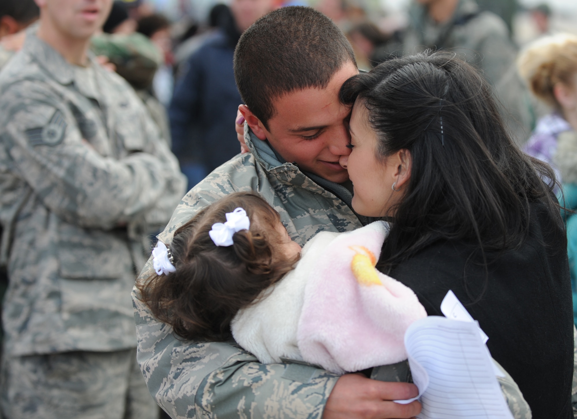 MOUNTAIN HOME AIR FORCE BASE, Idaho -- A family of an Airman from the 391st Aircraft Maintenance Squadron is reunited after his four-month deployment to Afghanistan Jan. 15. Nearly 20 F-15E Strike Eagles and approximately 400 Gunfighters were deployed to Afghanistan in support of Operation Enduring Freedom. (U.S. Air Force photo/ Senior Airman Ryan Crane)
