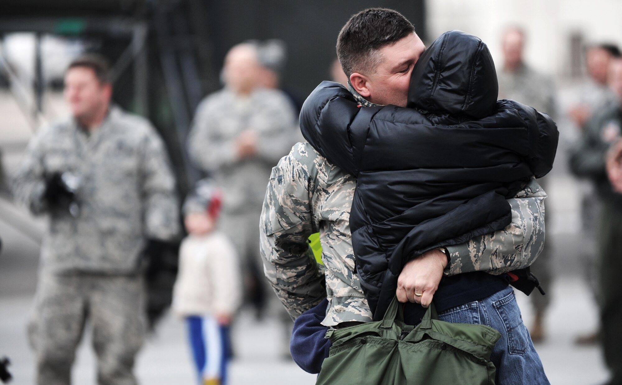 MOUNTAIN HOME AIR FORCE BASE, Idaho -- A father from the 391st Aircraft Maintenance Unit is reunited with his son and family following a four-month deployment to Afghanistan Jan. 15. Nearly 20 F-15E Strike Eagles and approximately 400 Gunfighters were deployed to Afghanistan in support of Operation Enduring Freedom. (U.S. Air Force photo/ Senior Airman Ryan Crane)