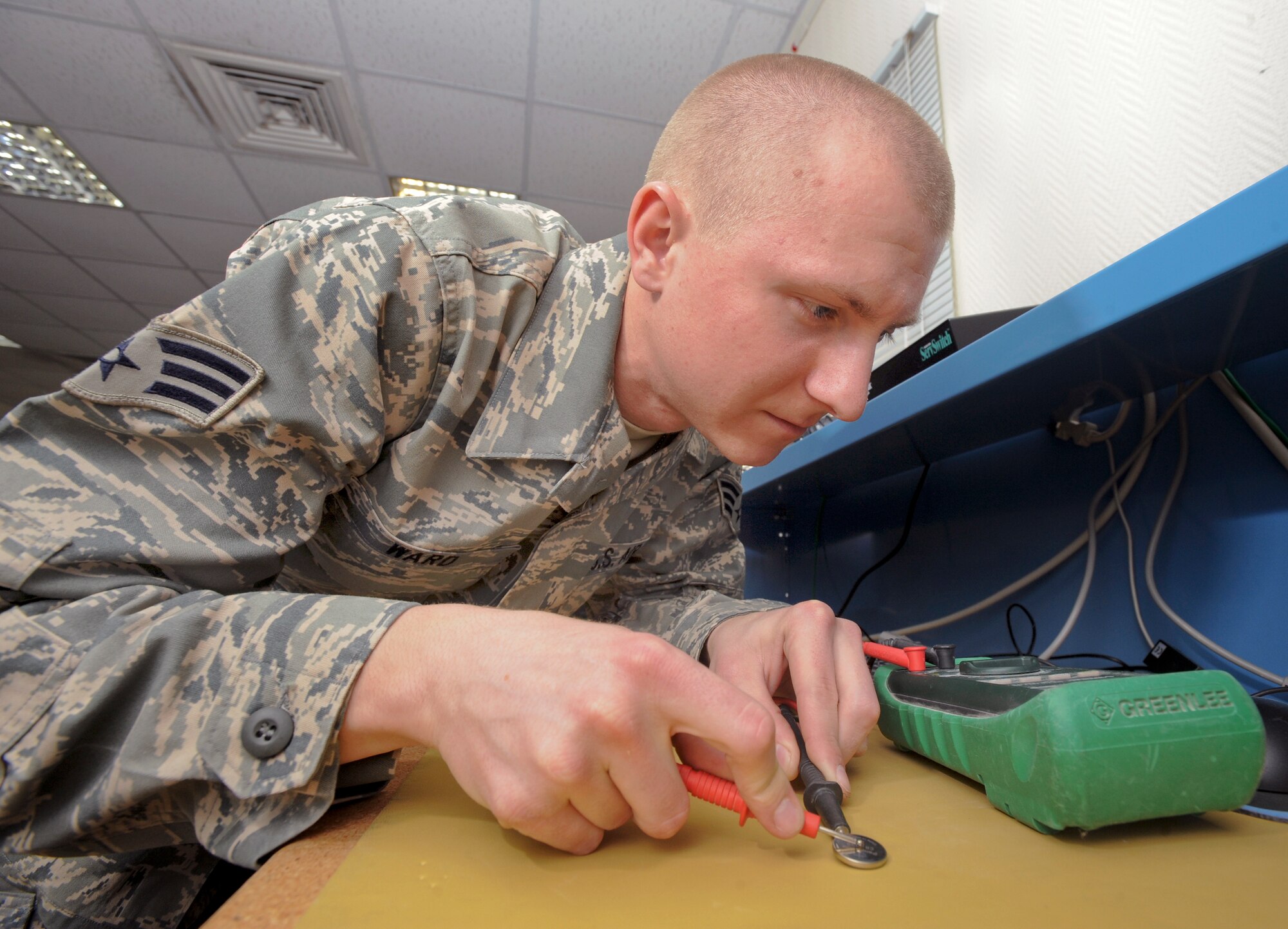 Senior Airman Ben Ward, a small computers technician with the 379th Expeditionary Communication Squadron, uses an ohm meter to ensure that the Complementary Metal Oxide Semiconductor (CMOS) chip is conducting energy, Jan. 15, 2009, in an undisclosed location in Southwest Asia. The CMOS is a battery that a computer uses to hold information such as the date and time while the computer is off. Airman Ward is a member of the 153rd Air Lift Wing of the Wyoming Air National Guard, his hometown is Cheyenne Wyo. and he is currently deployed in support of Operations Iraqi and Enduring Freedom and Joint Task Force-Horn of Africa.(U.S. Air Force Photo by Staff Sgt. Joshua Garcia/Released)