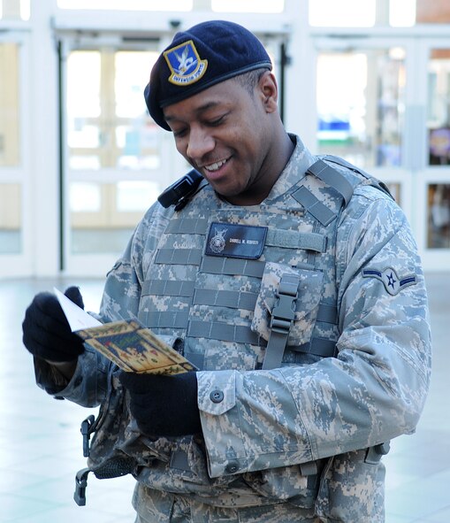 Airman Darrell Robinson, from the 100th Security Forces Squadron, smiles after reading a Christmas card sent from children across the U.S. inside the BX-tra lobby Jan. 14, 2009, at RAF Mildenhall, England. The American Red Cross distributed the Christmas cards for the children, thanking service members for all the sacrifices and wishing them happy holidays while away from home. (U.S. Air Force photo by Staff Sgt. Jerry Fleshman)