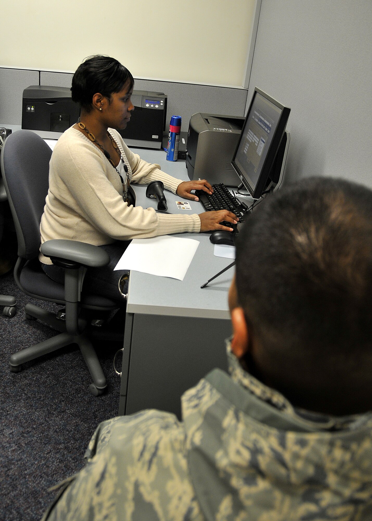 MISAWA AIR BASE, Japan -- Queena Knowles, 35th Security Forces Squadron, registers Master Sgt. Victor Vicuna's identification card for the Defense Biometric Identification System Jan. 16, 2009. The system requires all Status of Forces Agreement personnel assigned to Misawa Air Base and their dependents to register before April 1, 2009. (U.S. Air Force photo by Senior Airman Chad Strohmeyer)