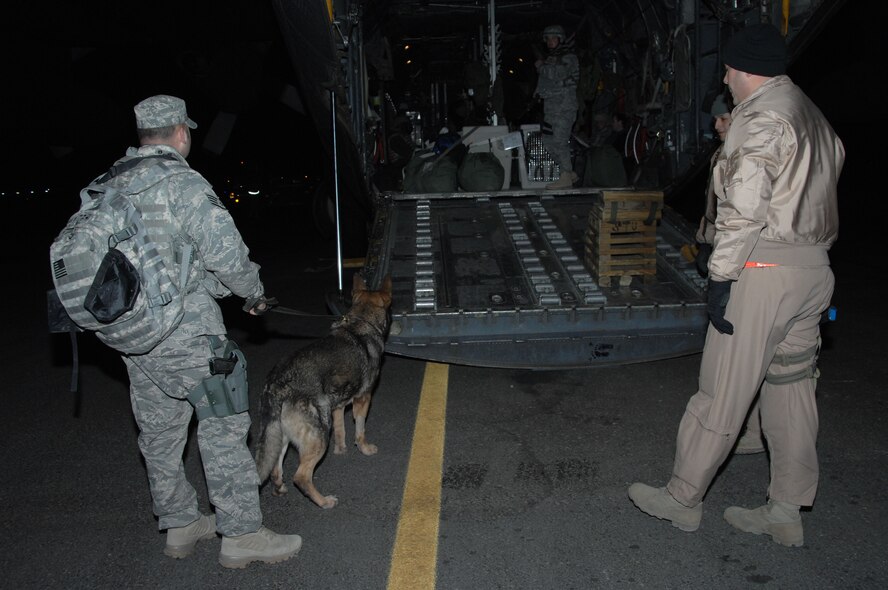 SOUTHWEST ASIA -- Staff Sgt. Joshua Germann, 822nd Security Forces Squadron, and Edo, Air Force military working dog, wait to board an aircraft taking them into Iraq at an air base in Southwest Asia, Jan. 13. Sergeant Germann and Edo are from Moody Air Force Base, Ga.   (U.S. Air Force photo/Senior Airman Courtney Richardson)