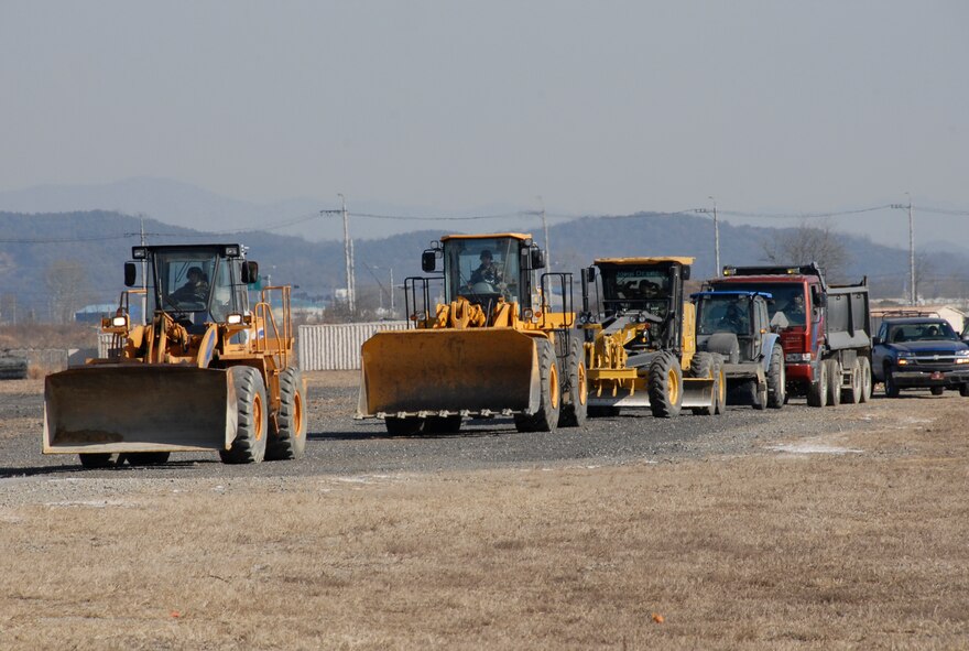 Osan Airfield Damage Repair Teams respond to a simulated crater on the Osan AB runway during Exercise Beverly Bulldog 09-01 on Osan Air Base Jan. 15 The ADR consists of highly trained Airman from the 51st Civil Engineering Squadron who are responsible for the assessment, design, repair and evaluation of methods to repair runway damage after an attack. The 51st Fighter Wing is currently undergoing a week-long Operational Readiness Exercise to test its ability to conduct war time missions. (US Air Force photo by Staff Sgt. Scottie T. McCord)