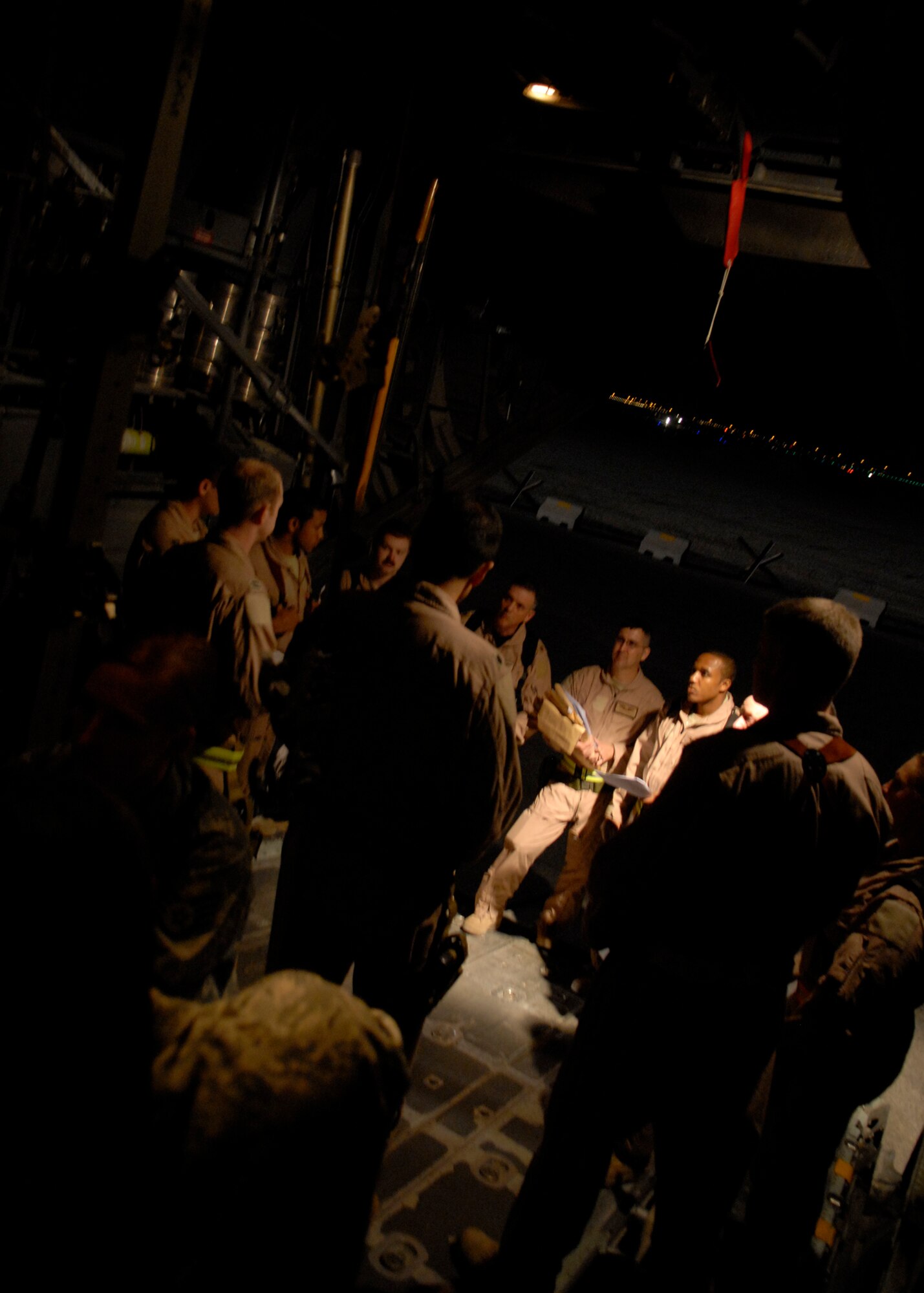Crewmembers from the 379th Expeditionary Aeromedical Evacuation Squadron receive their final briefing on the patient transport mission in a C-130, Jan. 11, 2009, at an undisclosed location in Southwest Asia. The unit airlifts patients with a wide variety of medical problems on tankers and cargo aircraft to locations around the area of operations where they can get the best treatment.  The squadron supports Operation Iraqi and Enduring Freedom, and Joint Task Force-Horn of Africa.  (U.S. Air Force photo/Airman 1st Class Andrew Satran)