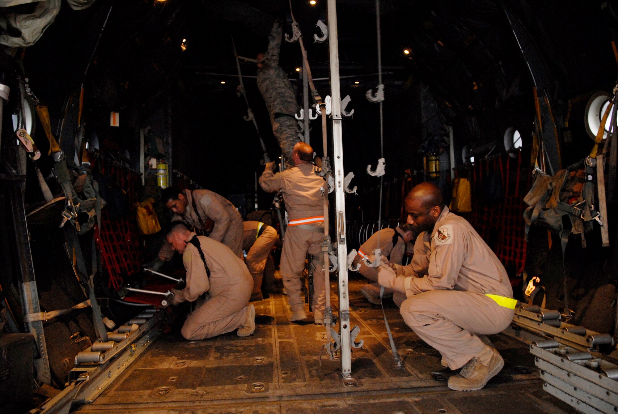 Members of the 379th Expeditionary Aeromedical Evacuation Squadron configure an aircraft to handle patients and medical equipment before a mission in the area of responsibility, Jan. 11, 2009, at an undisclosed location in Southwest Asia. The squadron transports patients throughout the AOR in support of Operation Iraqi and Enduring Freedom, and Combined Joint Task Force-Horn of Africa.  (U.S. Air Force photo by Airman 1st Class Andrew Satran/Released)