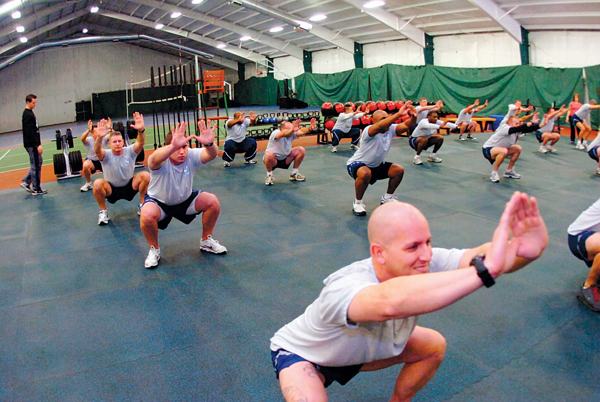 Commanders, superintendents and Team Andrews members give their best in the inaugural exercise session at the Tactical Fitness Center Jan. 15. The program builds core strength and endurance that are fundamental to a superior level of combat fitness, both as indiviuals and teams. The new Tactical Fitness Center replaces the multi-purpose room at the West Fitness Center. Class schedules will be posted at the main entrance of the fitness center, and individuals can work out in the the new TFC during normal operations. (U.S. Air Force photo by Bobby Jones)