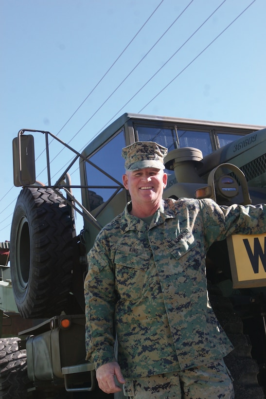 Master Gunnery Sgt. James C. King, motor transport maintenance chief, 1st Marine Division, stands next to a 10-ton M123A1C truck tractor, one of his favorite restored vehicles before his retirement ceremony held Friday at the mechanized museum.::r::::n::