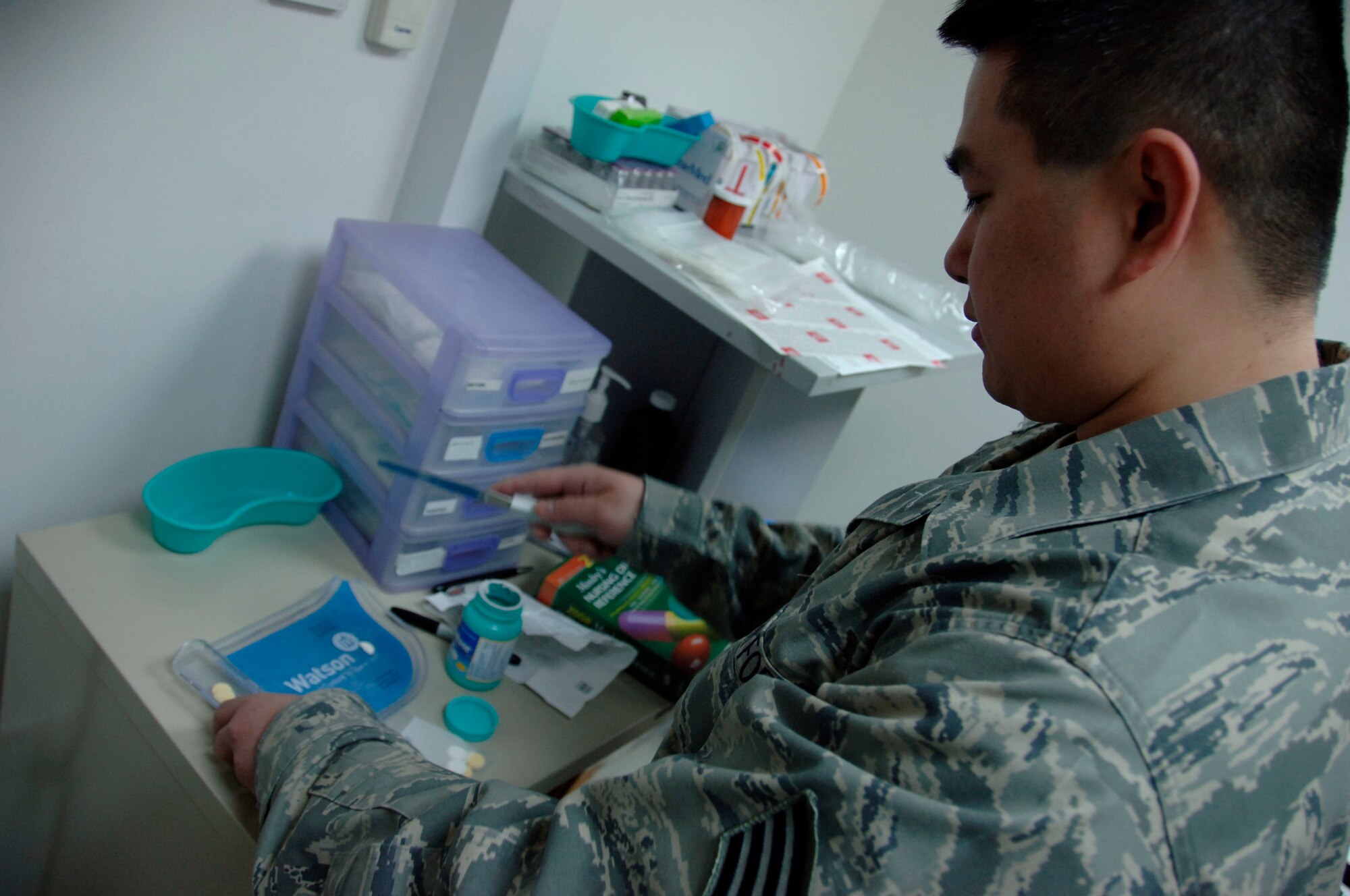 SOUTHWEST ASIA -- Staff Sgt. Edwardson Aquino, an independent duty medical technician assigned to the 380th Expeditionary Medical Group here, counts pills as he prepares a prescription for a patient. The 380th EMDG houses a general practice, flight medicine, public health, bioenvironmental engineering and life skills clinic. (U.S. Air Force photo by Staff Sgt. Mike Andriacco) (Released)
