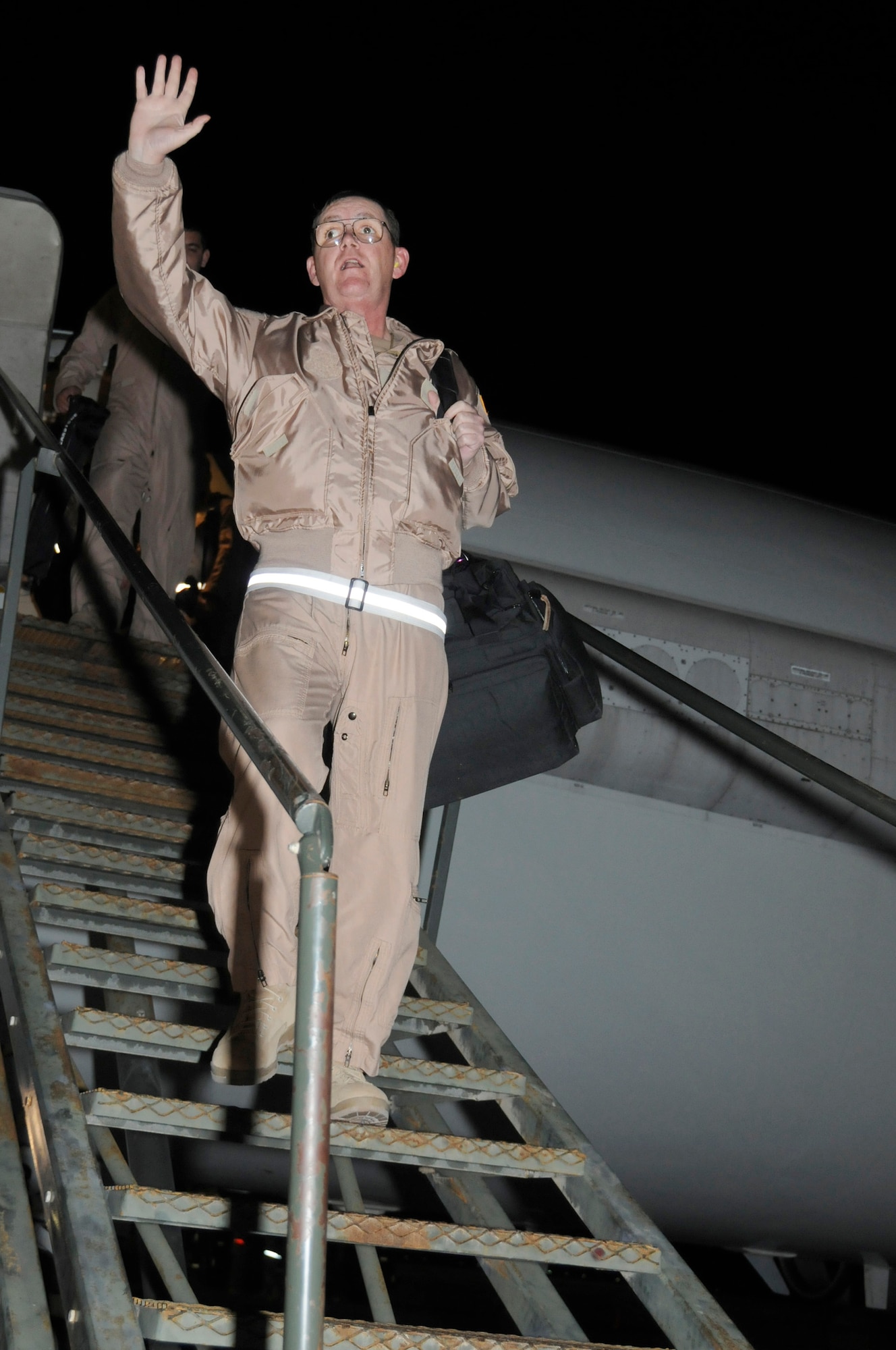 SOUTHWEST ASIA -- Maj. Jon Williams, 963rd Expeditionary Airborne Air Control Squadron mission crew commander, exits an E-3 Sentry to a round of applause,  Jan. 16. Major Williams reached a milestone of flying hours as an air battle manager on an E-3 with a year's worth of hours (8,760 hours). Major Williams is from Edmond, Okla. and his home station is Tinker Air Force Base, Okla. (U.S. Air Force photo by Senior Airman Brian J. Ellis) (Released)