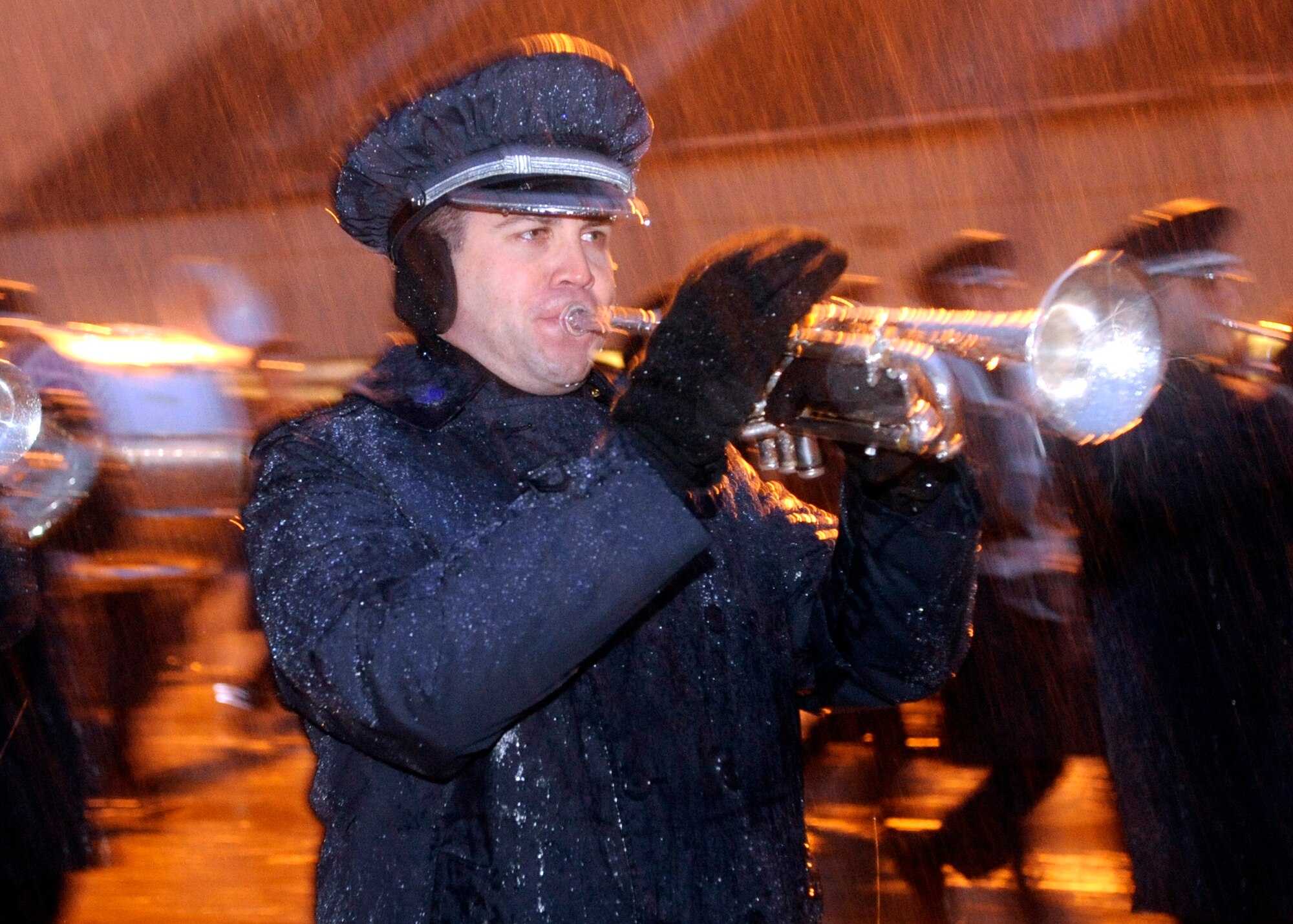 Tech. Sgt. Chris Pagnard practices songs while marching in the morning rain Jan. 7 at Andrews Air Force Base, Md., in preparation for the inauguration of President-elect Barack Obama. (U.S. Air Force photo/Master Sgt. Cecilio M. Ricardo)
