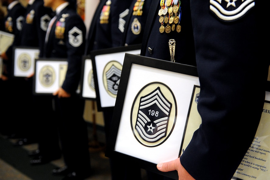 MOODY AIR FORCE BASE, Ga. -- The Moody senior master sergeants selected for promotion to the rank of chief master sergeant hold a frame which contains a certificate and a chevron with their line number at the Chief Recognition Ceremony here Jan. 17. Only one percent of the enlisted force can hold the rank of chief master sergeant in the Air Force. (U.S. Air Force photo by Senior Airman Gina Chiaverotti)