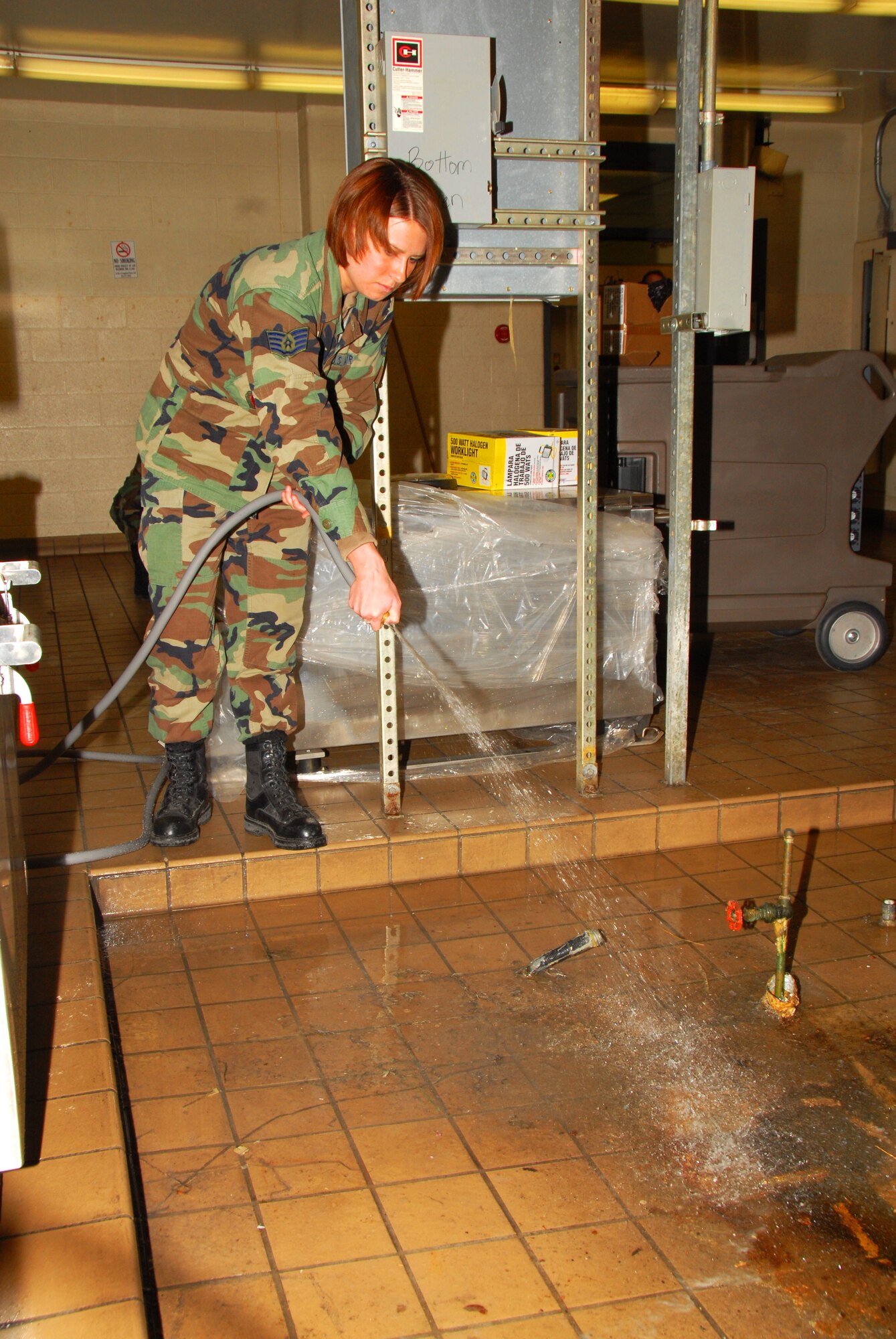 Staff Sergeant (SSgt) Rebecca Hepke of the 132 Fighter Wing, Des Moines, Iowa, cleans a drainage area in preparation for setting up services area on 17 January, 2009.  SSgt Hepke is supporting Iowa Army National Guard during the inauguration of President-elect Barack Obama.   (US Air Force Photo by TSgt Brian Cox)(Released by MSgt Vincent DeGroot, Public Affairs Manage