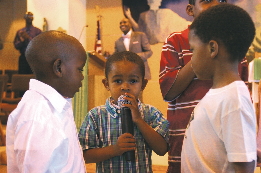 Gabriel Trusty and other children of the Blinder Memorial Chapel, Marine Corps Base Camp Pendleton, Calif., sang during the celebration of Dr. Martin Luther King Jr. Jan 18. Parishioners experienced a celebration of singing, dancing, role playing and refreshments.