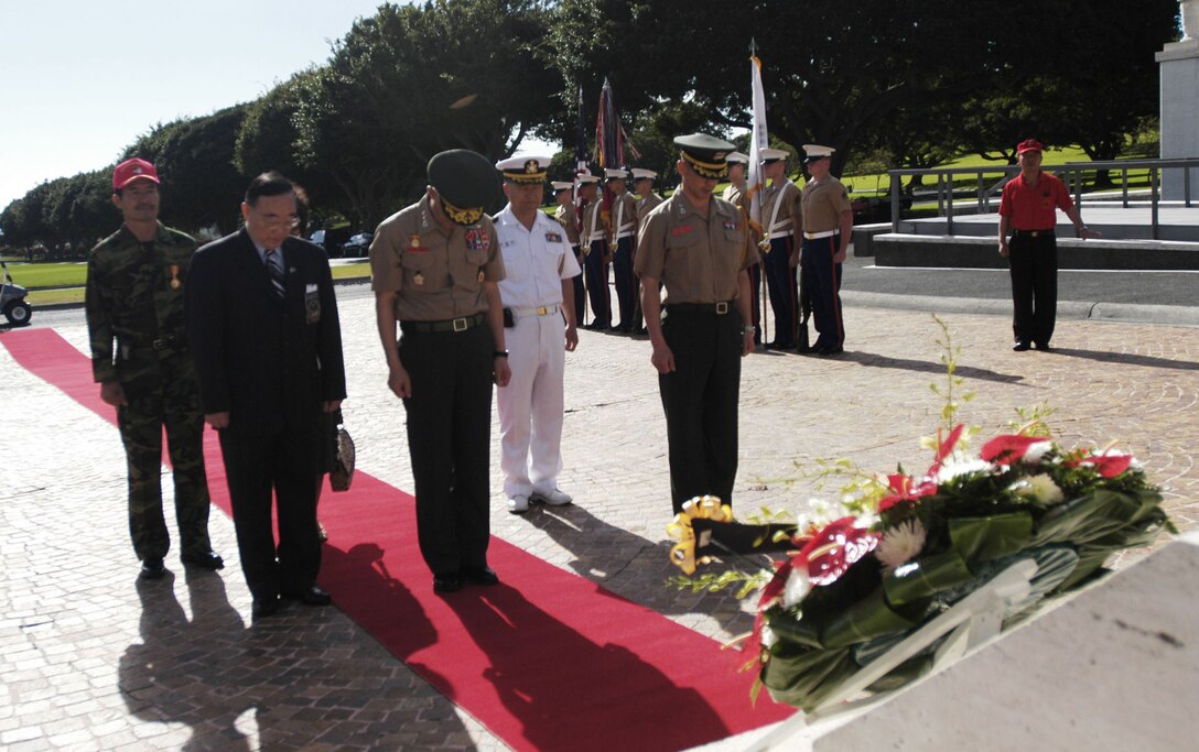 The commandant of the Republic of Korea Marine Corps, Lt. Gen. Lee Hong Hee (front, center), and an official party bow their heads in tribute to fallen service members who fought for his country more than 50 years ago.