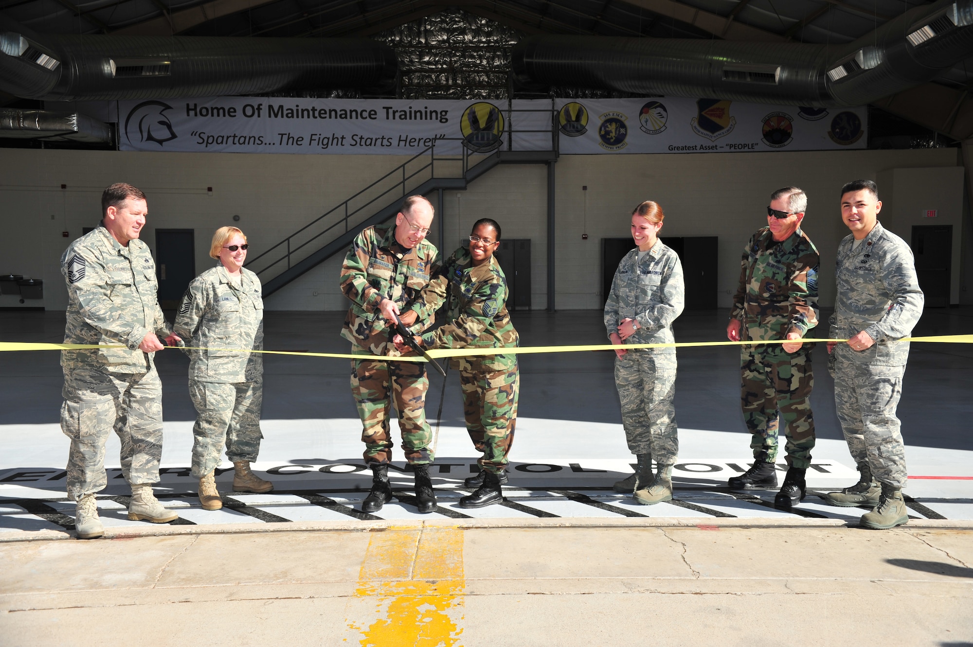 Col. Dennis Shumaker, the 355th Maintenance Group commander, and Master Sgt. Leigh Alexander, from the 355th Maintenance Operations Squadron, cut a ribbon to commemorate the  grand opening of the Maintenance Training Complex at Davis-Monthan Air Force Base, Ariz.,  Jan. 9. The new facility, used to house the Maintenance Training Flight and Weapons Standardization Section, will provide space to train more than 2,000 students annually to support the base's fleet of 113 A-10 Thunderbolt, C-130 Hercules, and HH-60 Pave Hawk aircraft.