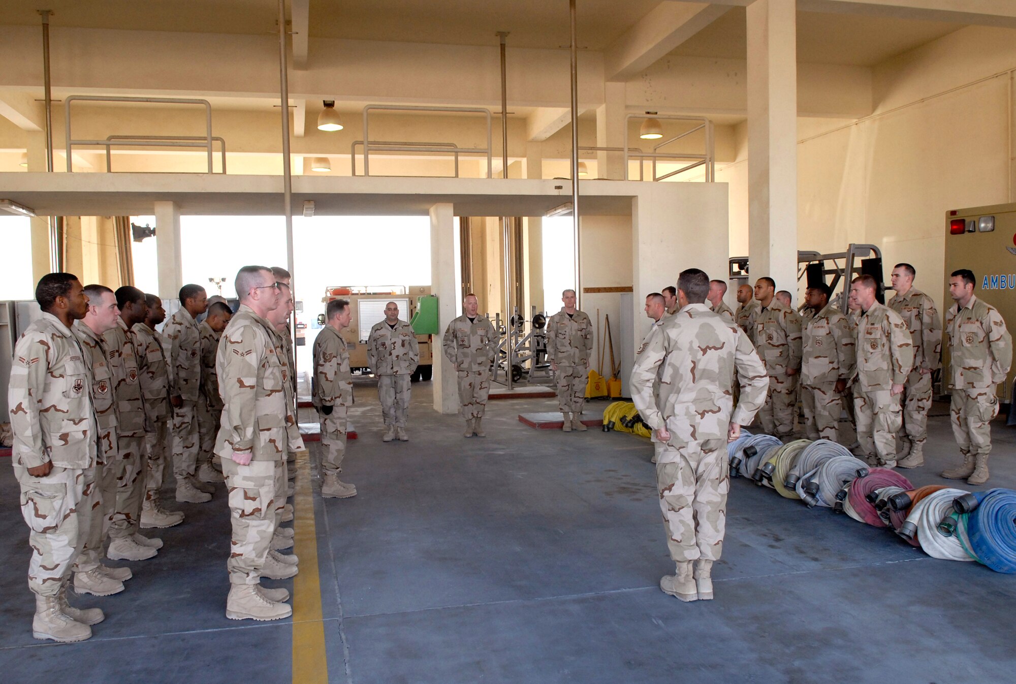 379th Expeditionary Civil Engineering Squadron Flightline Station Fire Fighters form up during their morning shift change, Jan. 17, 2009, at an undisclosed location in Southwest Asia.  The morning formation also welcomed incoming Airmen recently deployed from over nine different Air Force bases in support of Operation Iraqi and Enduring Freedom and Joint Task Force- Horn of Africa.   (U.S. Air Force Photo by Airman 1st Class Andrew Satran/Released)