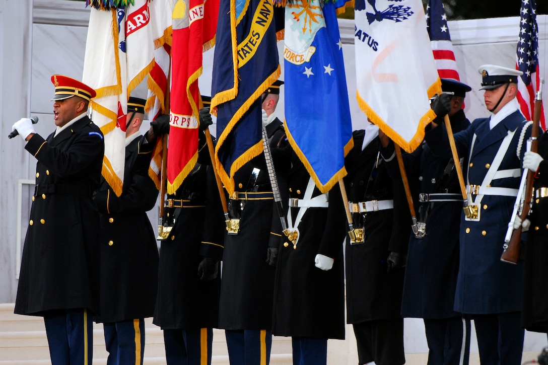 Marine Master Sgt. Caleb Green sings the national anthem during the ...